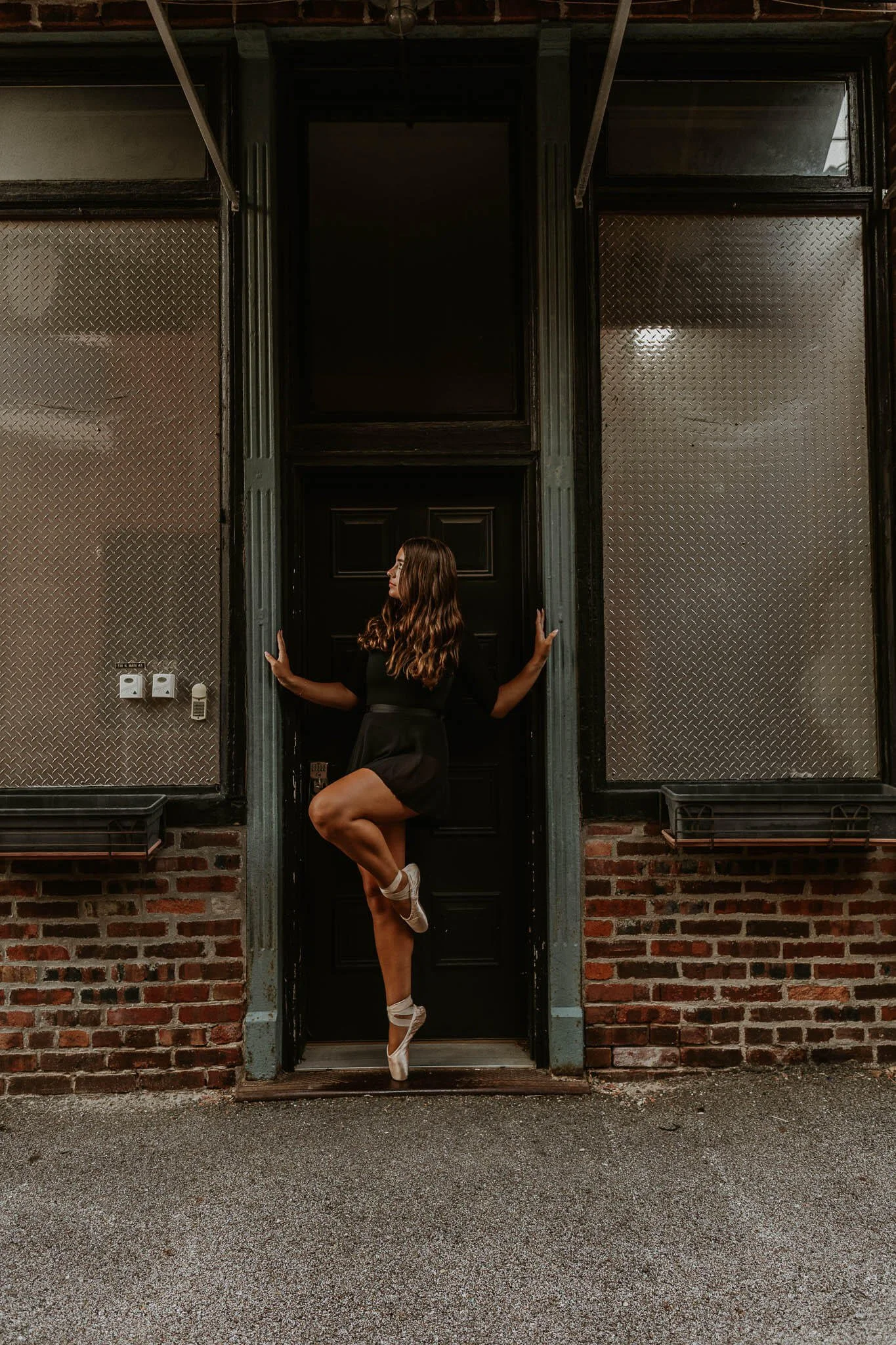 A ballerina strikes a pose in a doorway