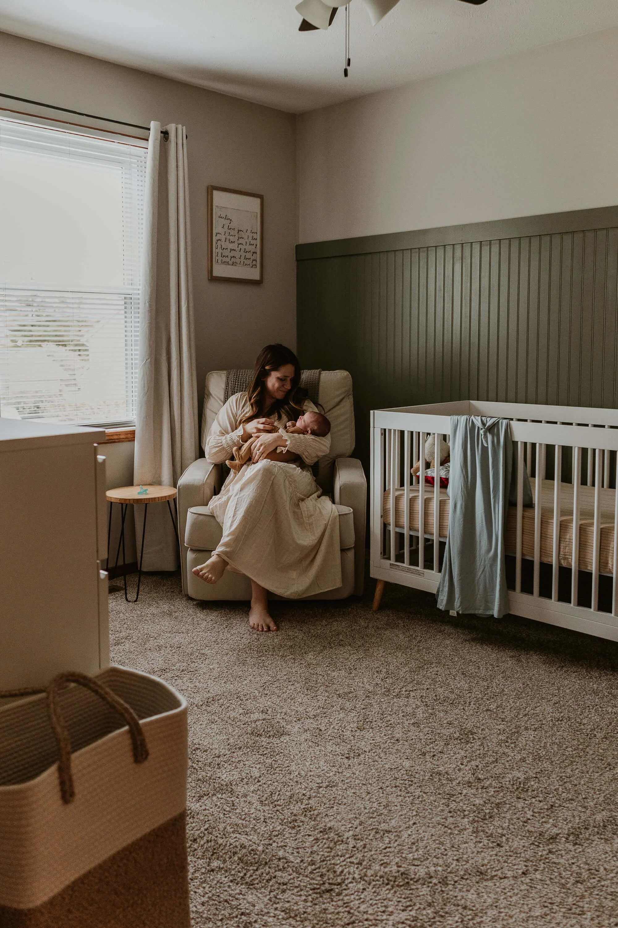 A new mother rocks her infant son in his nursery just weeks after his birth