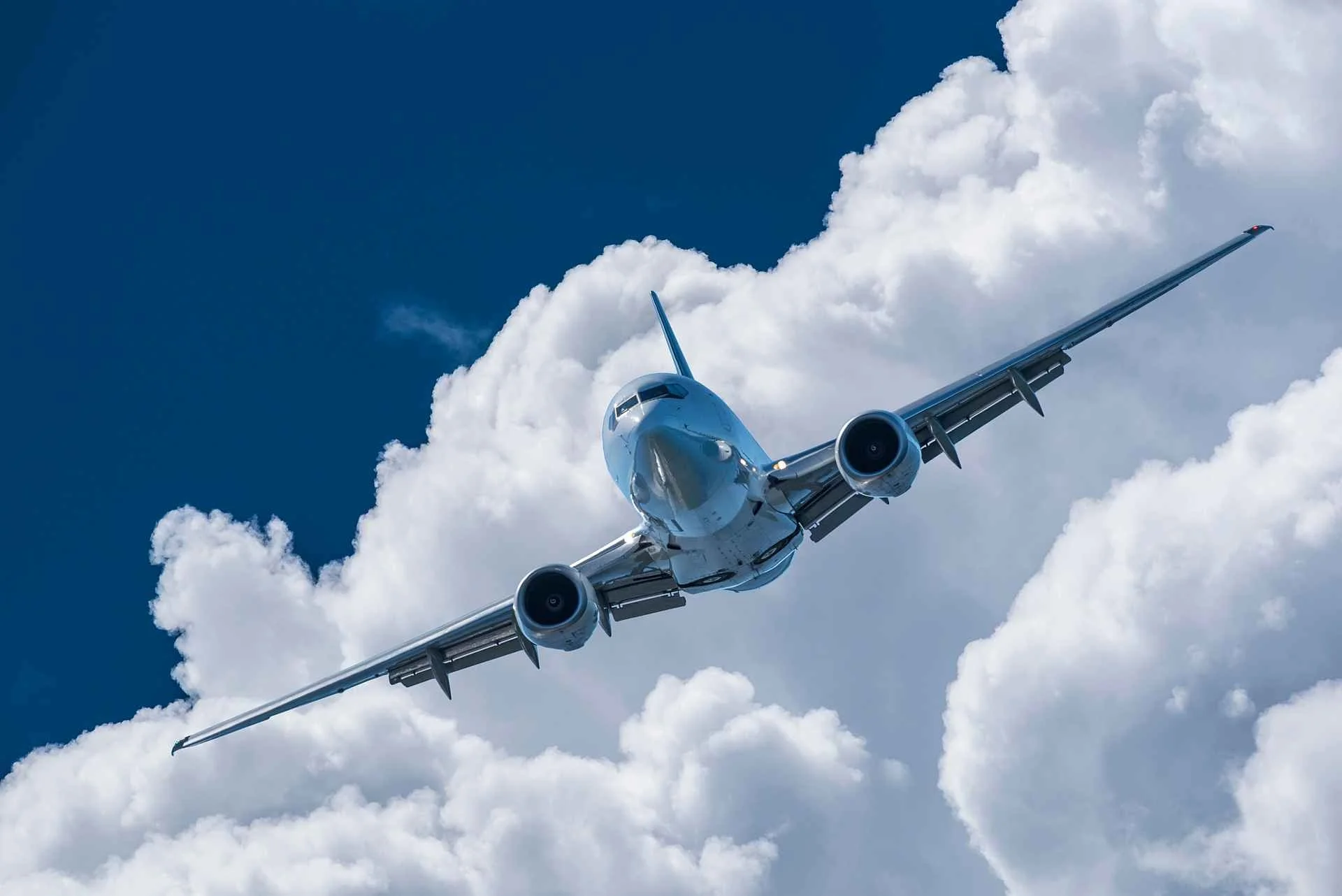 jet-airplane-aircraft-flying-clouds-600w-1157121754.jpg