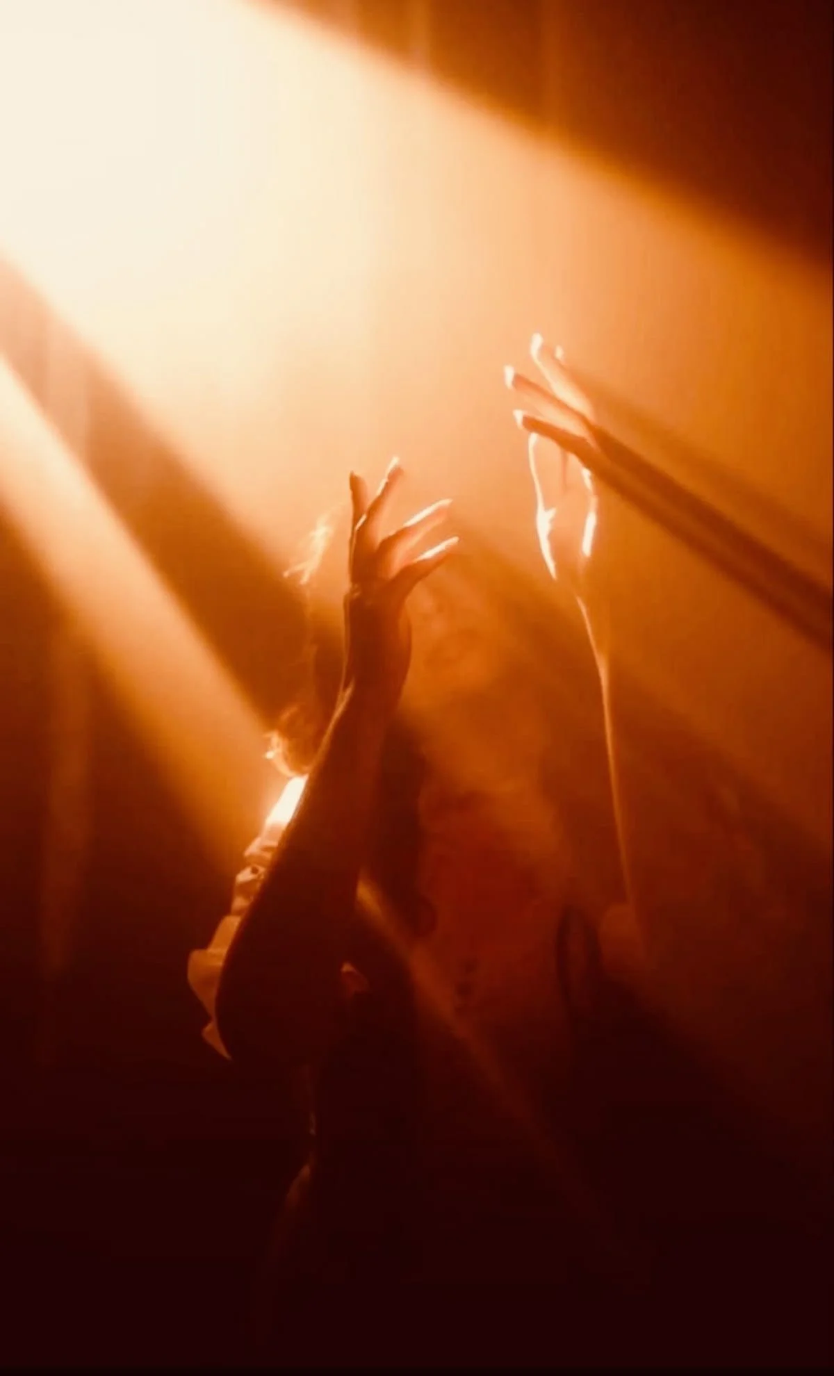 Person with raised hands bathed in warm golden light, symbolising worship, devotion, and building an altar to God rather than seeking visibility