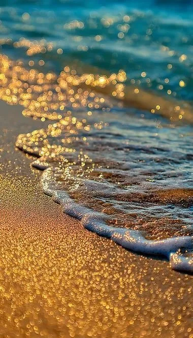 Sunlit waves washing over golden sand, sparkling with light — symbolising the beauty, intimacy, and mystery of walking with God daily