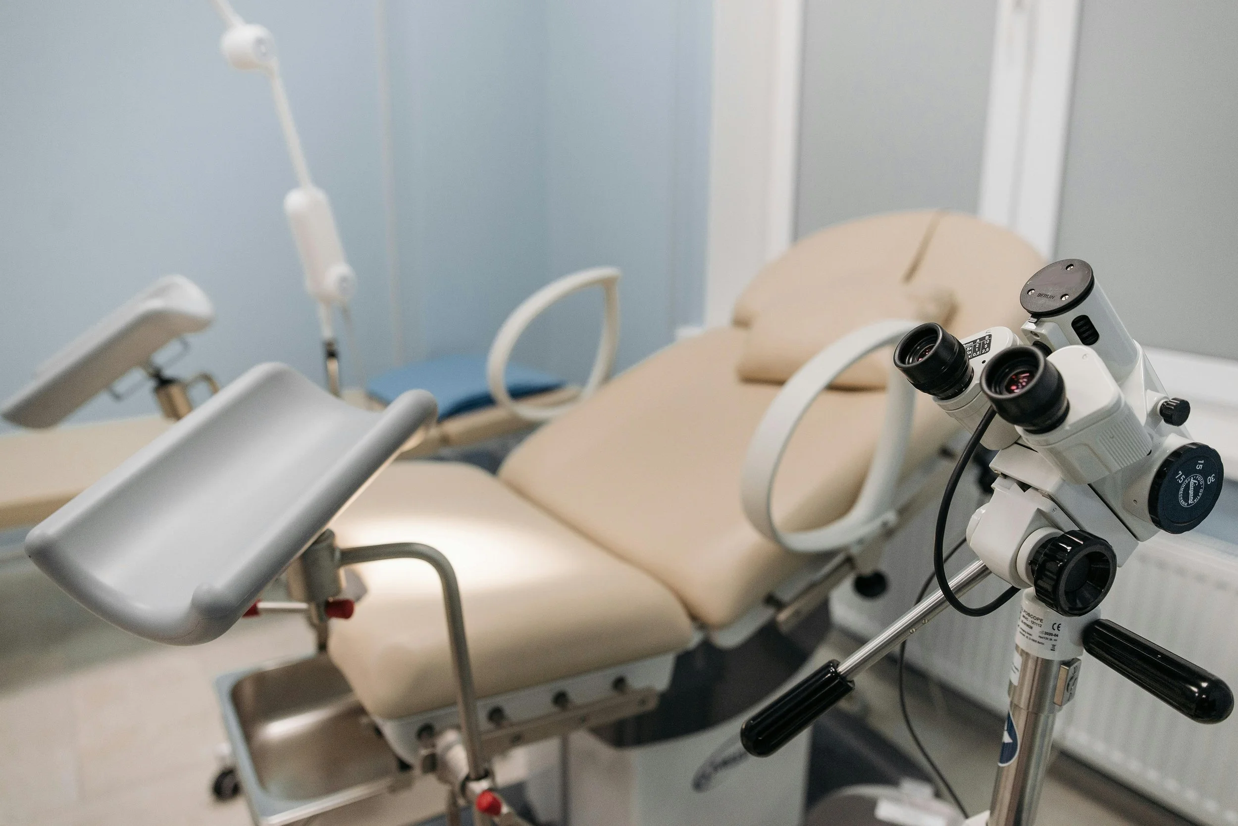 A gynaecological examination couch in a hospital room.