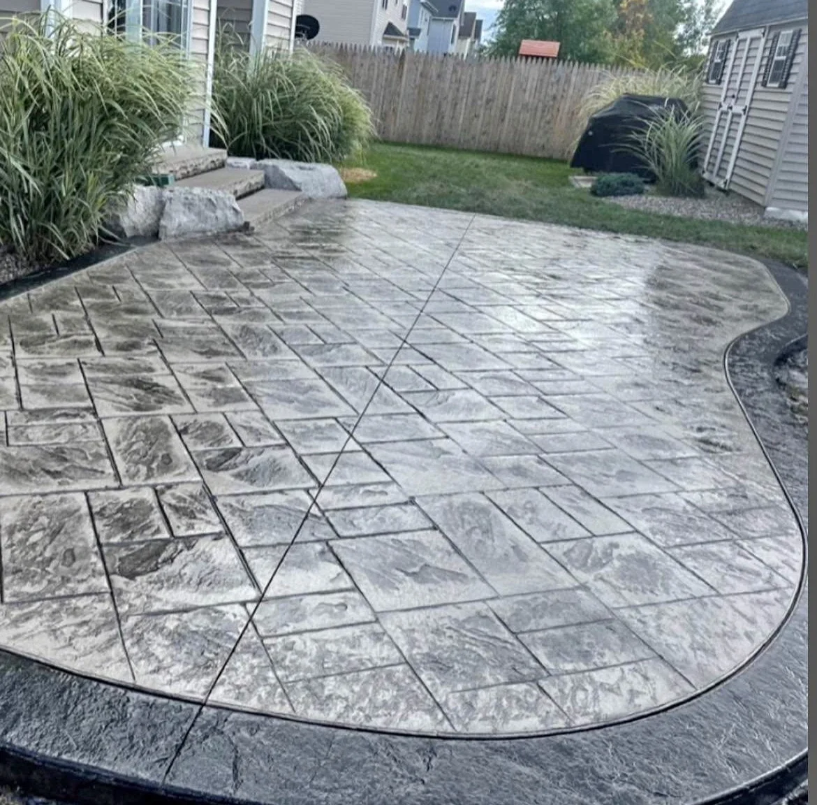 Stamped concrete with slate pattern in New Boston New Hampshire. Custom border edge with a gloss finish.