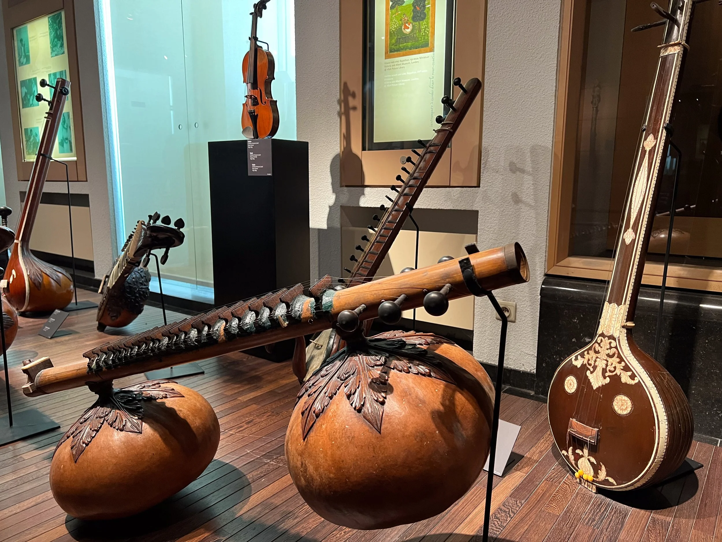 In the foreground is a type of Indian zither, a rudra veena.
