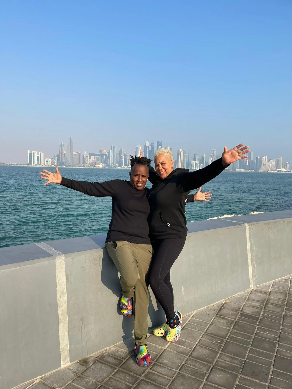 Two women standing on a bridge in Qatar