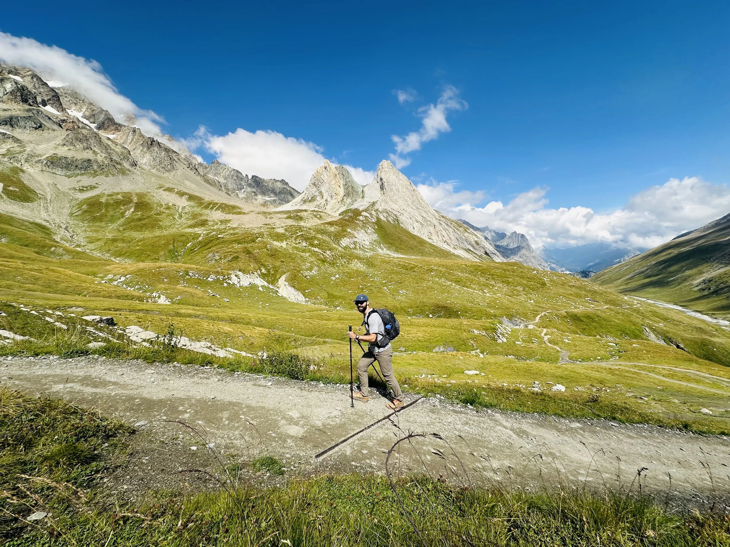 Gianni Puglielli hiking in the Alps with a backpack and trekking poles