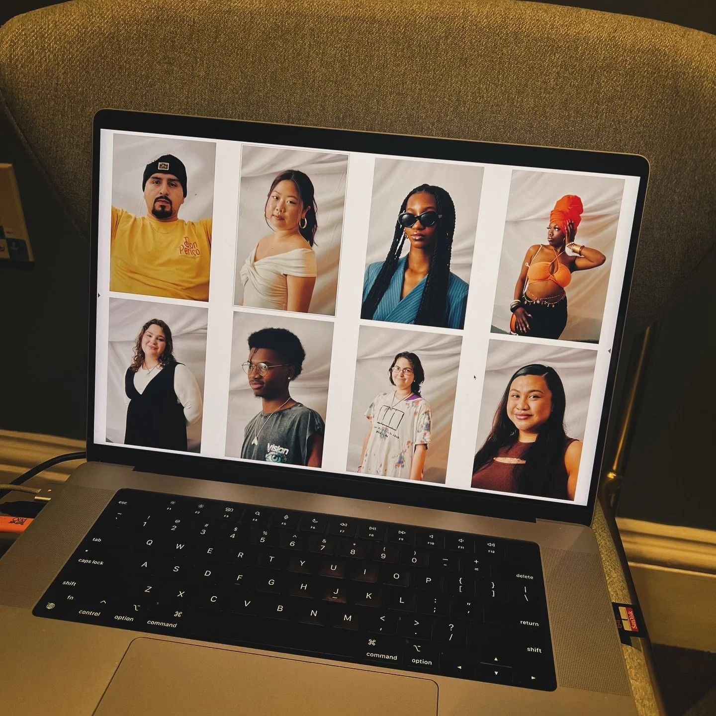 Laptop screen displaying a collage of eight diverse portrait photos of people, arranged in a 3x3 grid with one empty space, all against a white background.