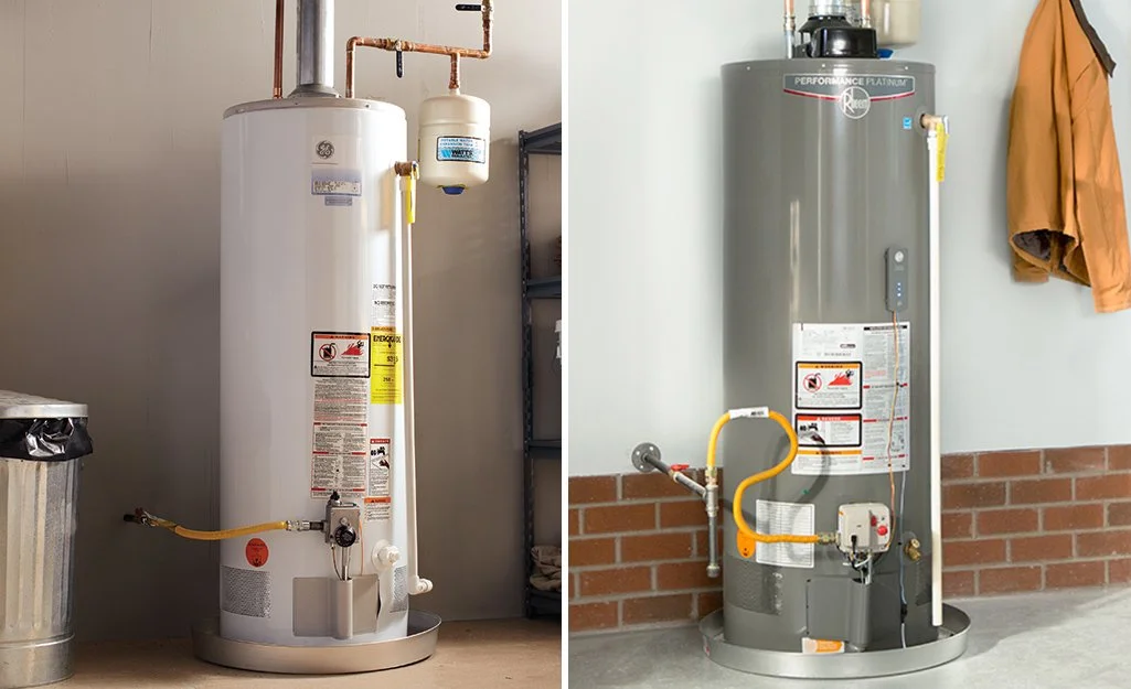Side-by-side comparison of two water heaters in different settings. The left is a tall, white gas water heater, and the right is a shorter, gray electric water heater mounted against a wall with a brick base.