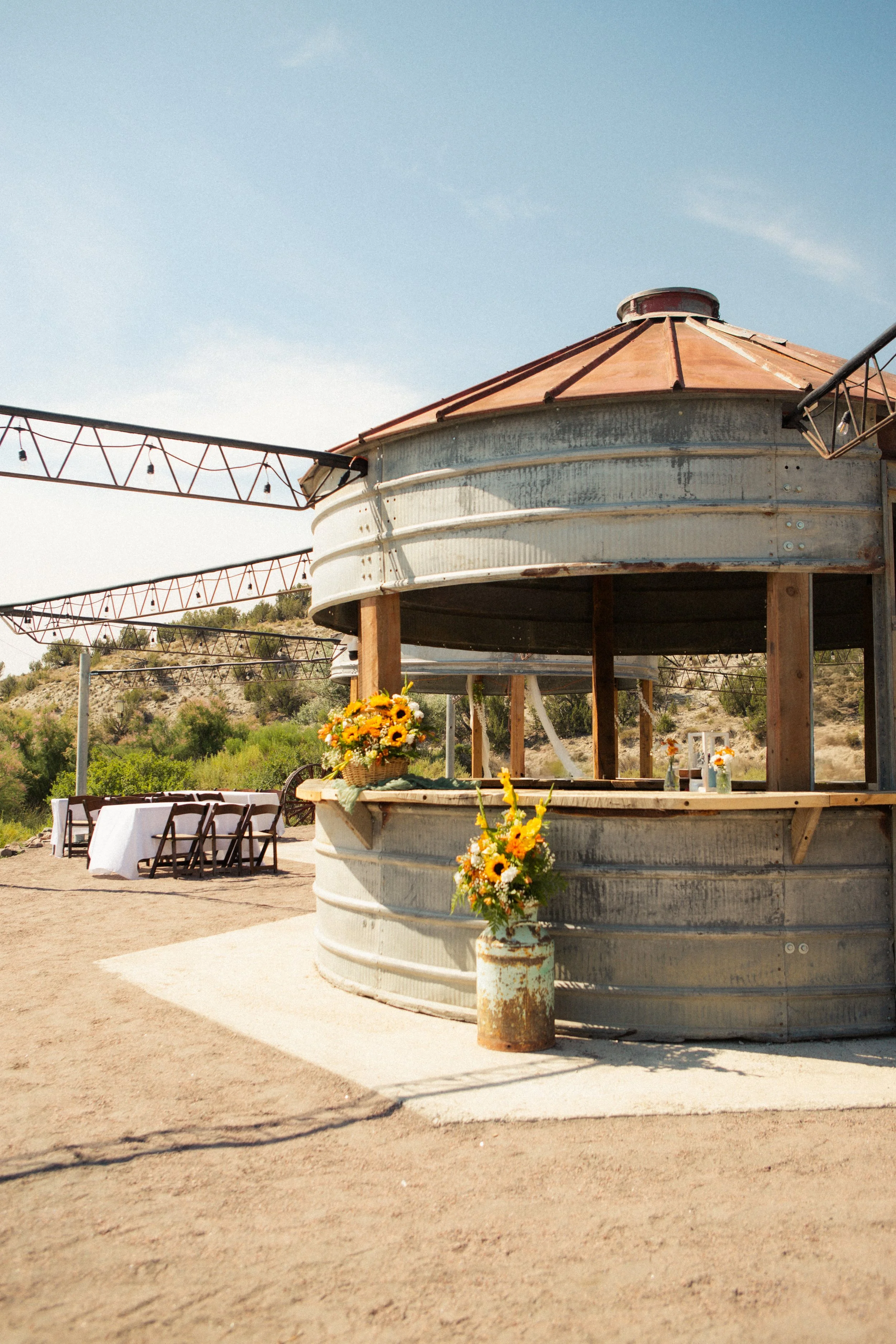 ,360 degree silo bar decorated for a wedding with sunflowers at outdoor wedding venue Lost Pond, located near Pueblo, Colorado Springs, and Canon City, Colorado.
