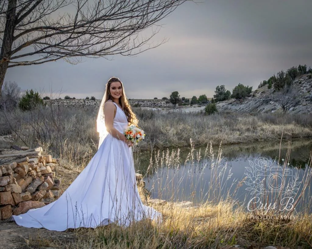 Bride next to the water at Lost Pond wedding venue outdoor ceremony site near Canon City, Colorado