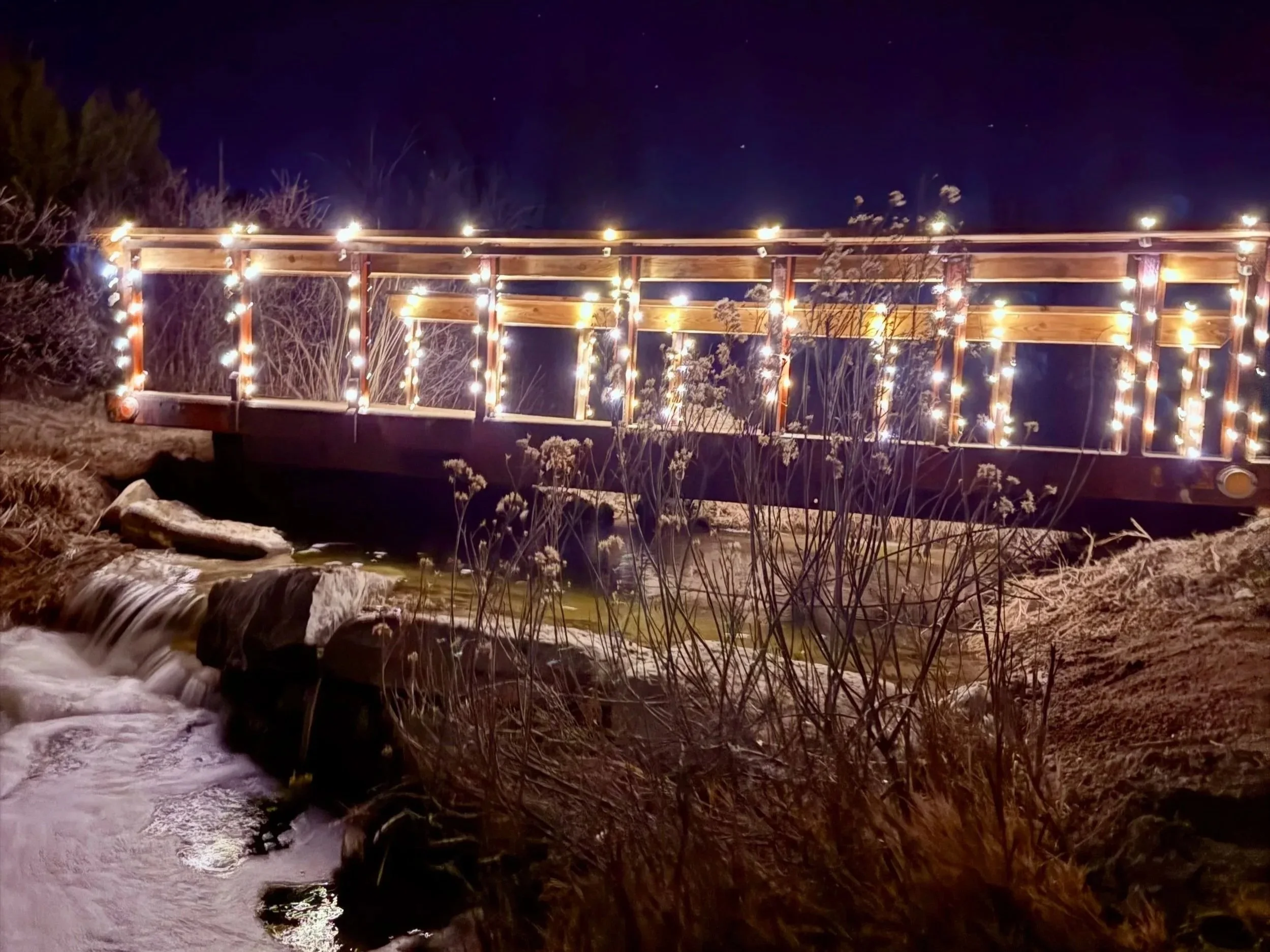 Bridge over the waterfall and natural stream water features at Lost Pond wedding venue near Florence, Colorado Springs, Pueblo, and Canon City, Colorado