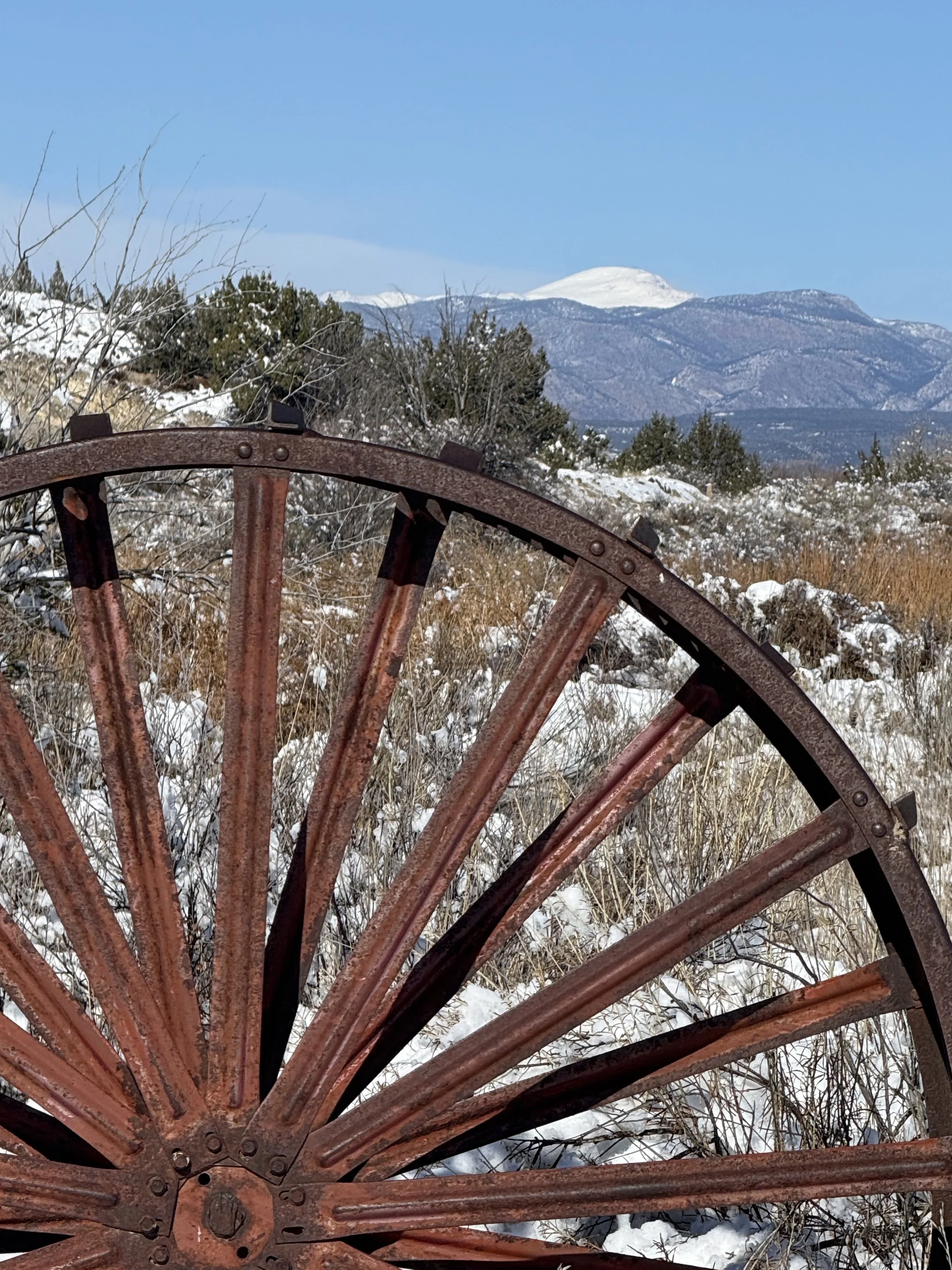 Antique, rustic wagon wheel at Lost Pond wedding venue near Canon City, Colorado.