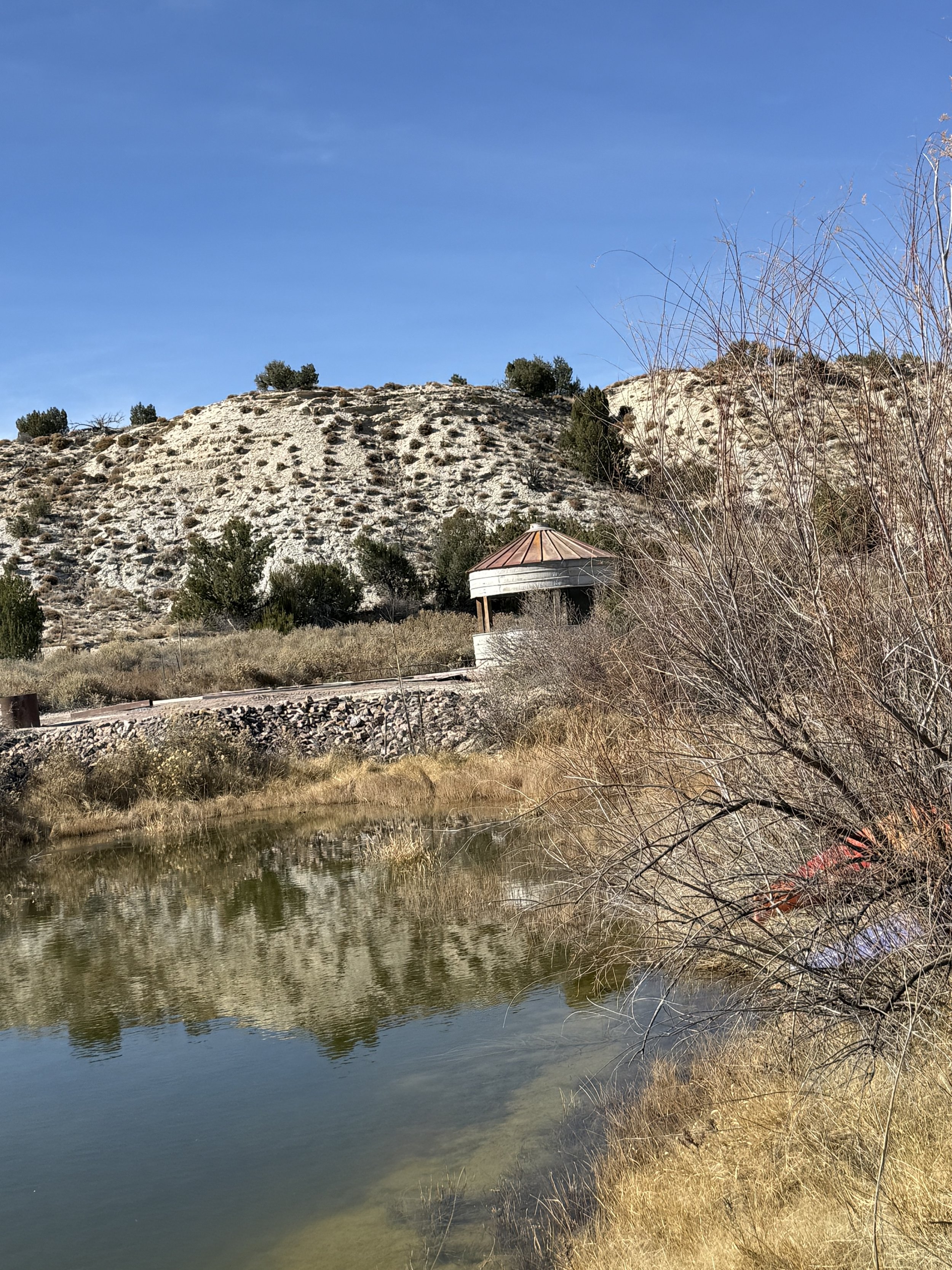 Silo accross pond at wedding reception area at Lost Pond wedding venue in Penrose Colorado