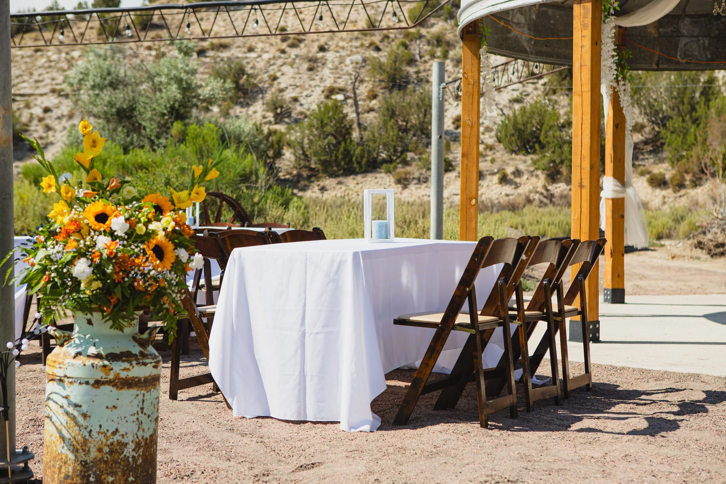 Outdoor pondside wedding reception under the string lights and under the stars with mountain views behind you near Colorado Springs, Colorado.