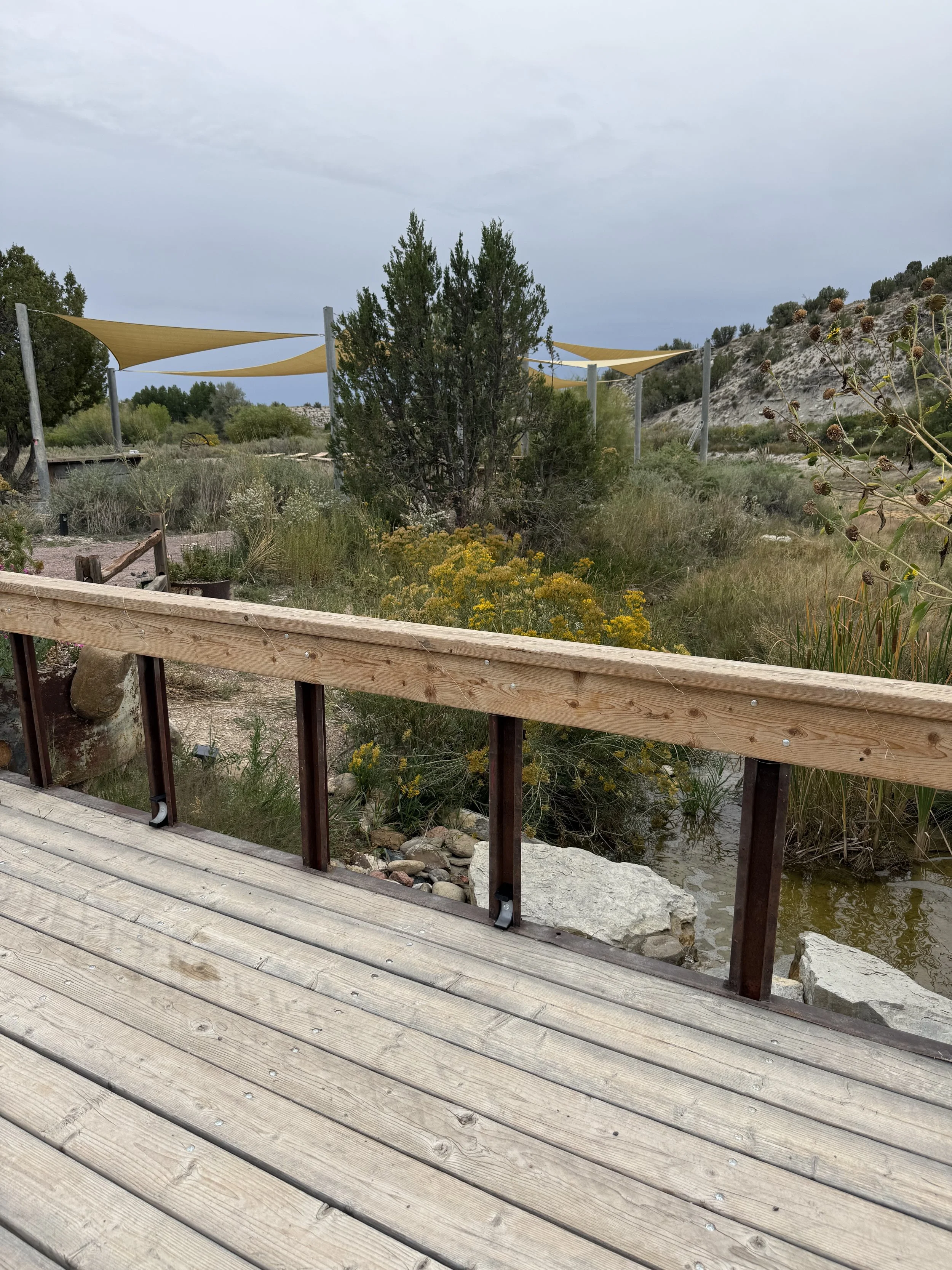 Rustic bridge over the stream at outdoor wedding venue Lost Pond located between Pueblo and Canon City, Colorado.