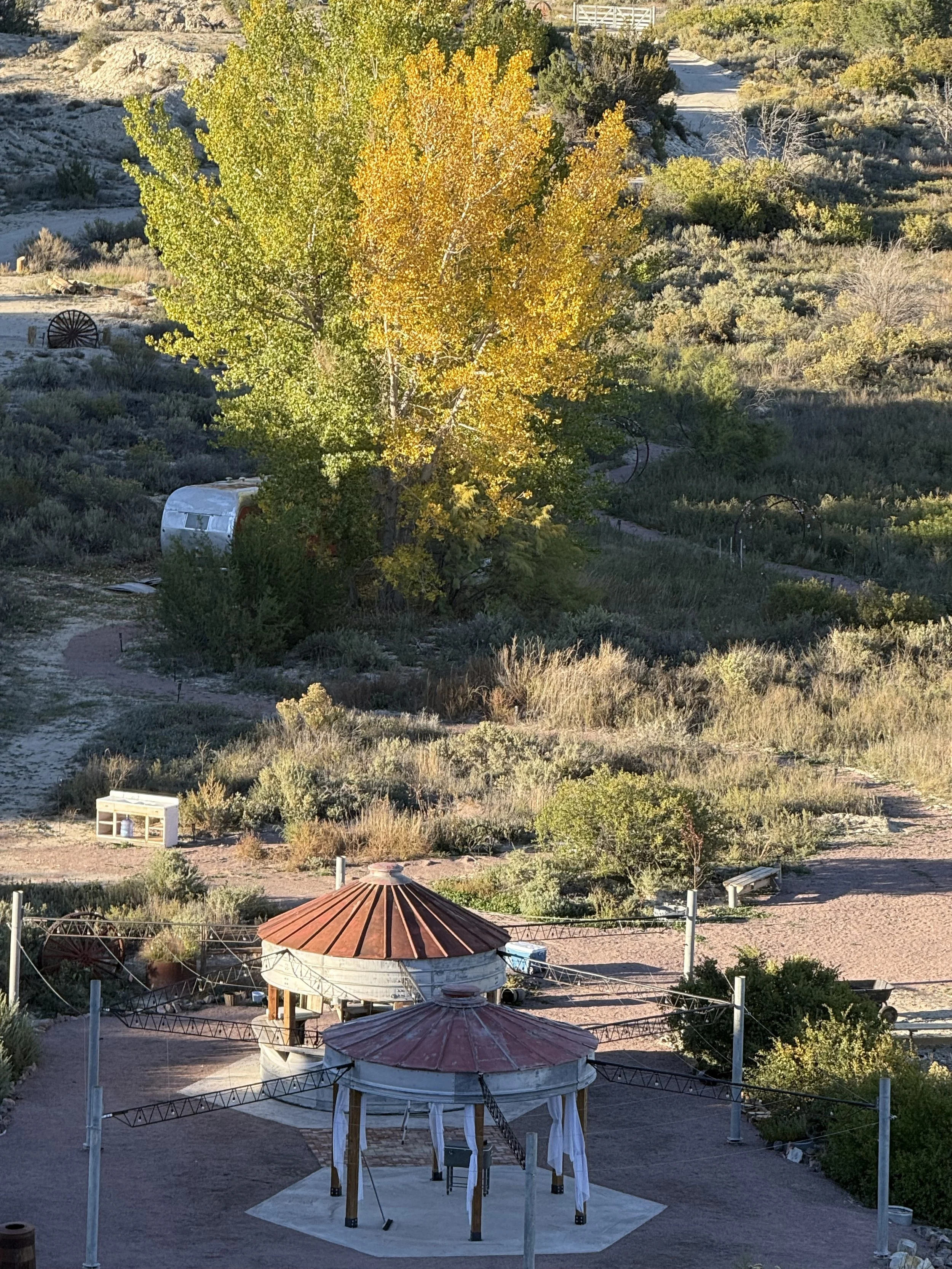 Looking at an overhead view of Lost Pond wedding venue near Canon City, Colorado. This rustic venue has a rustic feel with the grain silo dance floor and 360 degree silo bar.