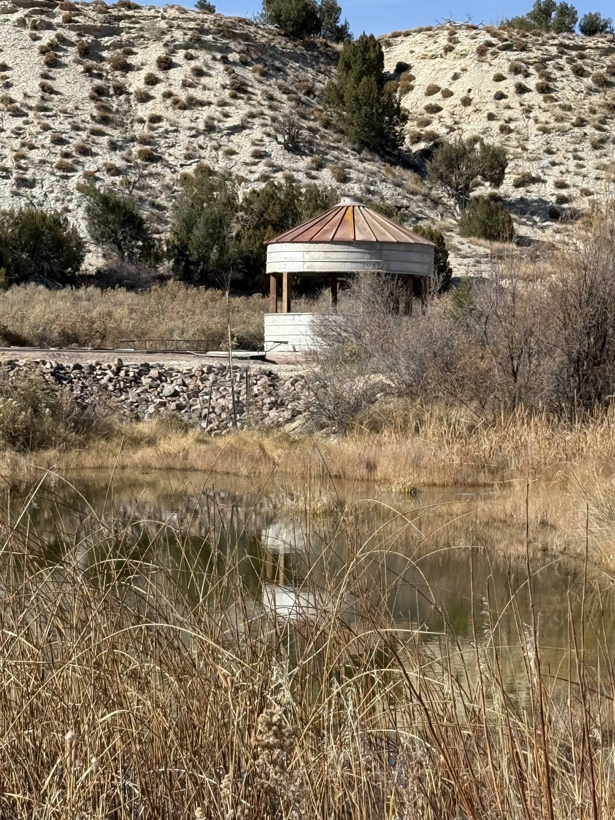 Rustic Silo across water at waterfront garden wedding venue near Canon City Colorado