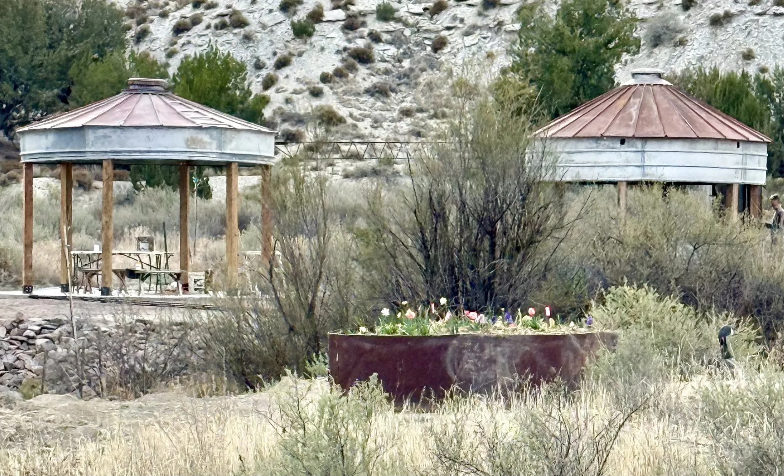 Twin silos reflect of the pond at the waterside wedding reception site at Lost Pond wedding venue near Cañon City, Colorado