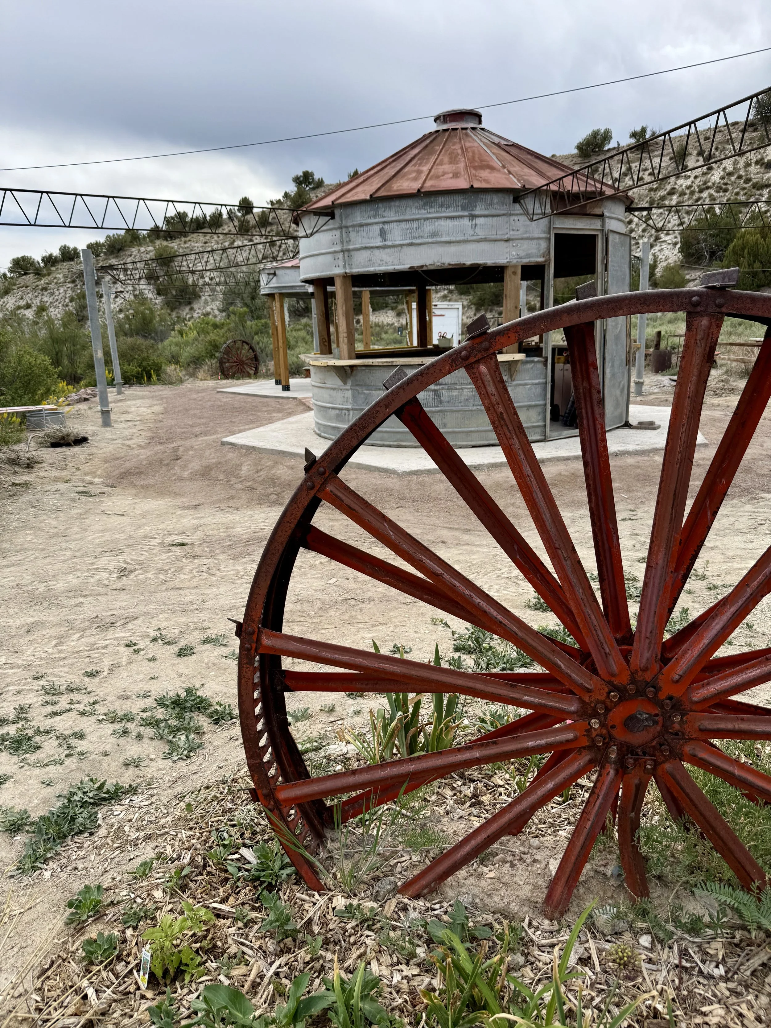 Grain bin silo and vintage wagon wheel at Lost Pond wedding venue an outdoor wedding venue near Colorado Springs, Colorado.
