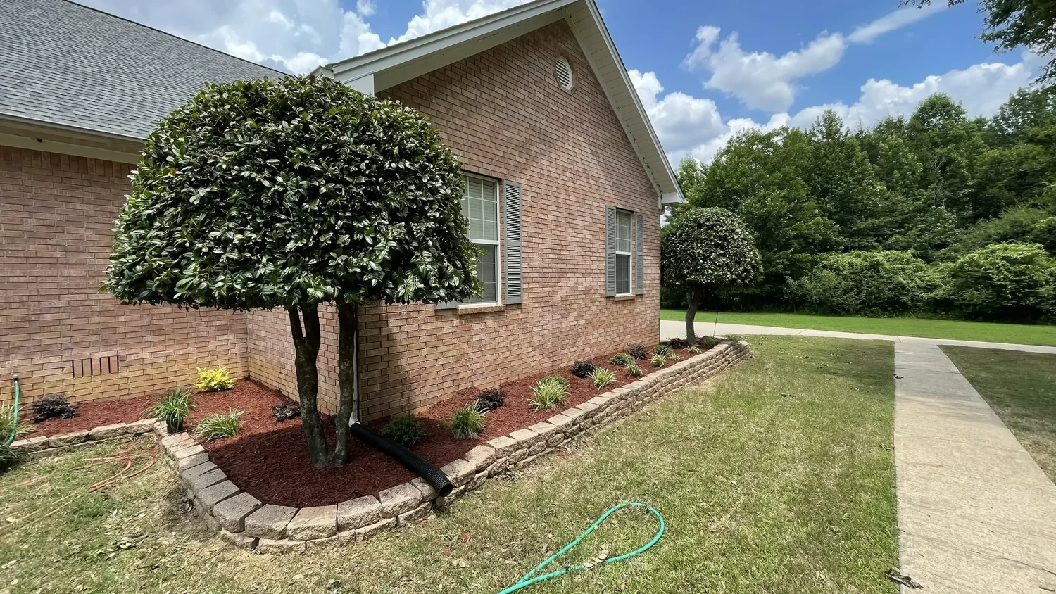 Fresh landscape bed and plant installation by White River Lawn