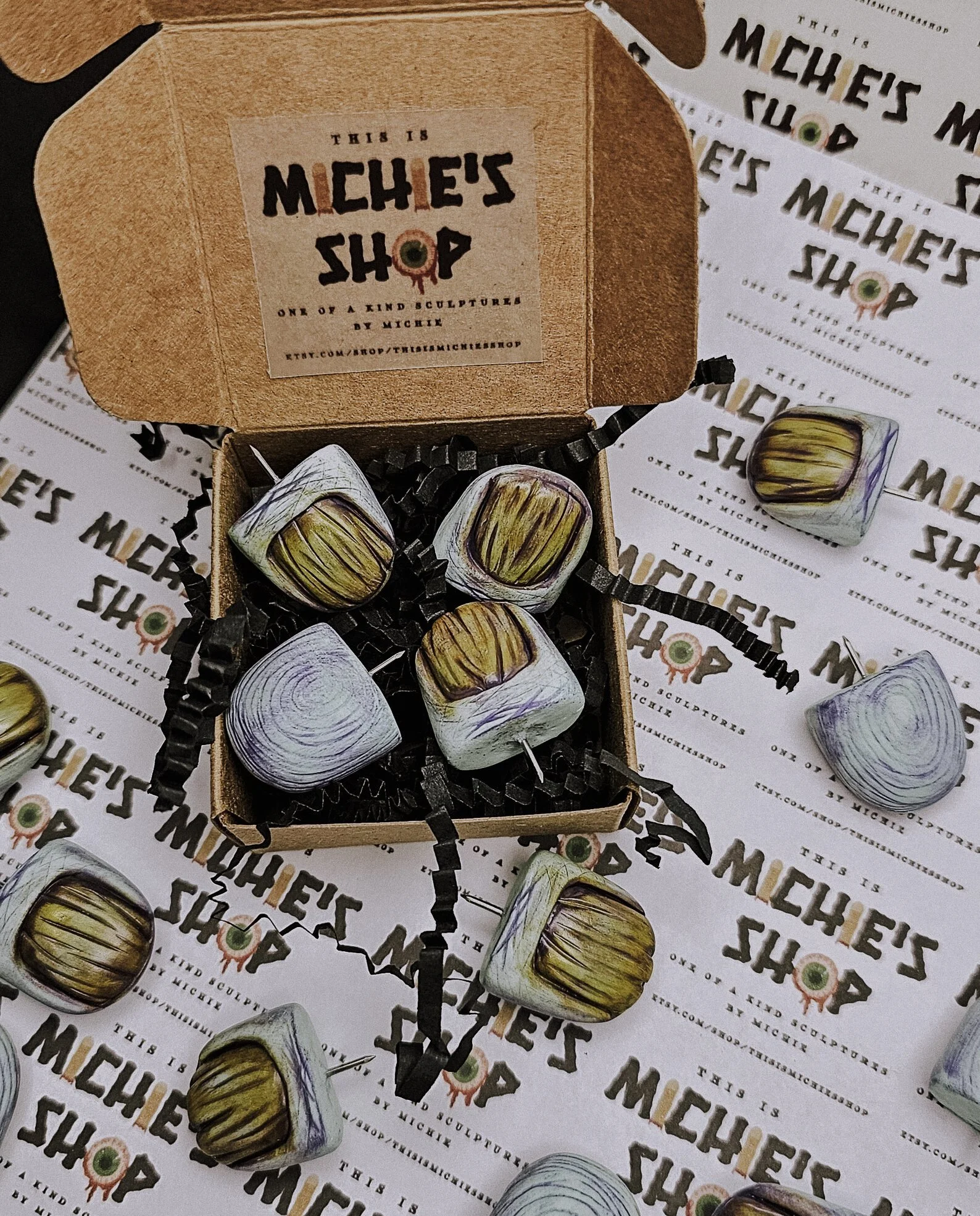 Take your corkboard from blah to braaaains. These zombie-themed thumb tacks feature tiny fingers and brains for a hilarious and horrifying touch of undead flair. Perfect for Halloween, horror fans, or the office ghoul in your life.