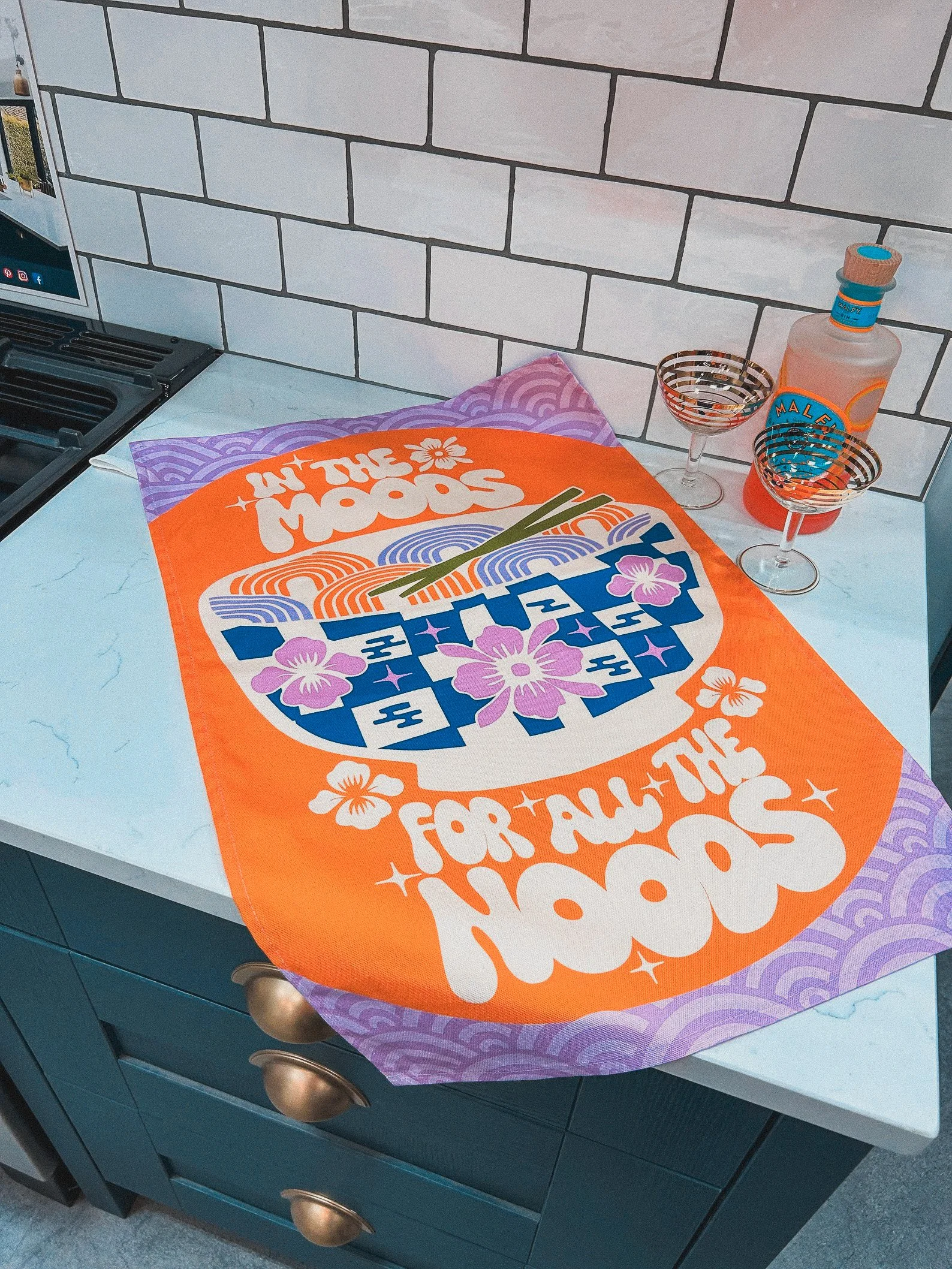Hilarious noodle-themed tea towel with “In the Mood for Noods” phrase, ideal for ramen lovers, pun fans, and kitchen sass enthusiasts.