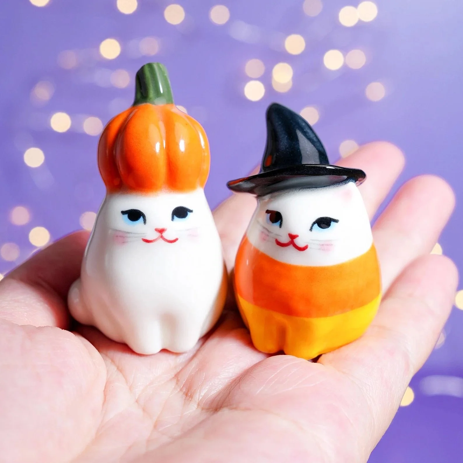 These handmade Halloween cat figurines are here to bring spooky cuteness in the tiniest, most chaotic form possible. Each one is crafted with Halloween flair, from pumpkin hats to little ghost friends, making them perfect for shelf styling, tiered tr