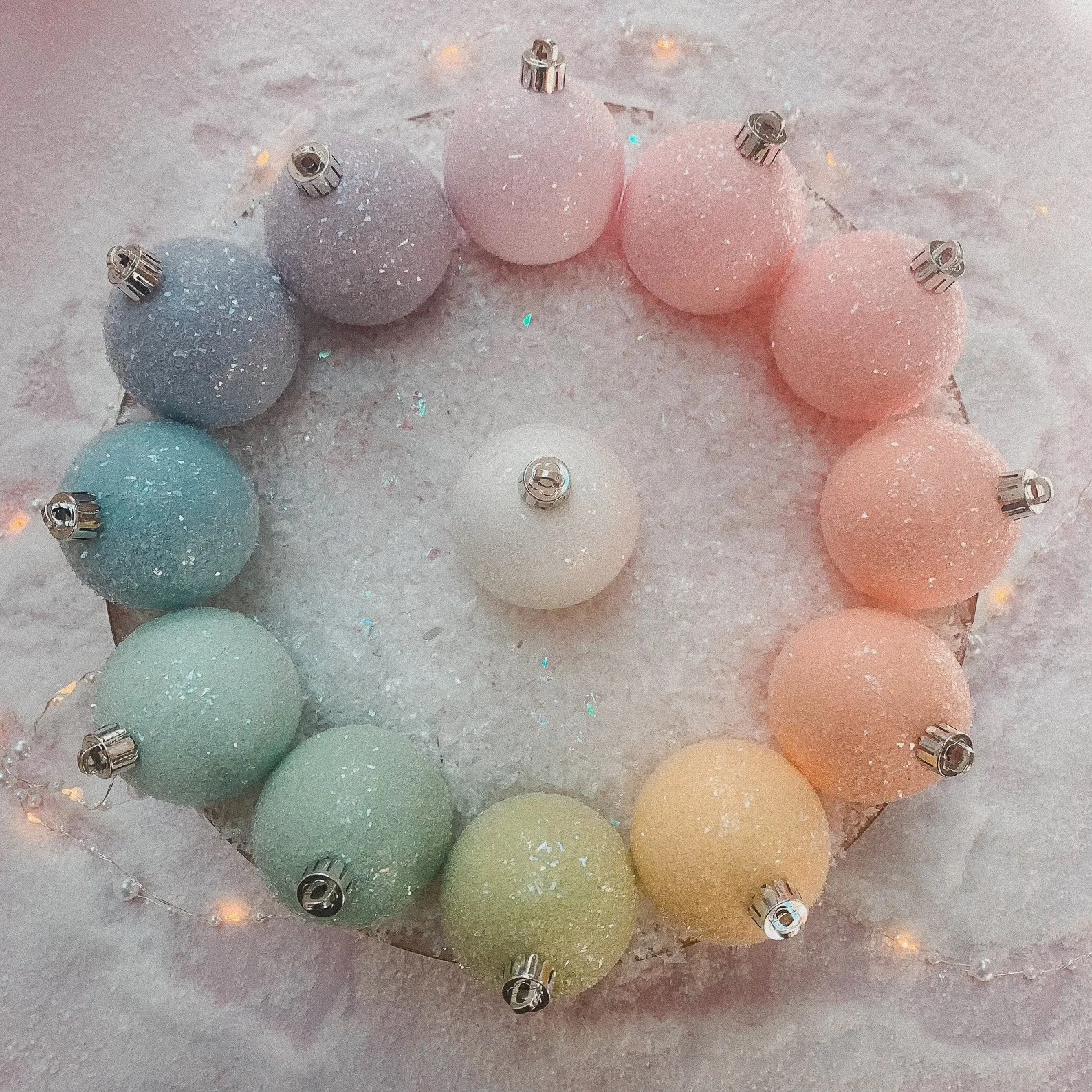 These pastel glitter baubles from TildaLovesTeddy are a delightful addition to any holiday decor. Hand-painted in your choice of soft hues and finished with a sugared sparkle, they evoke the charm of vintage candy ornaments. Available in sizes rangin