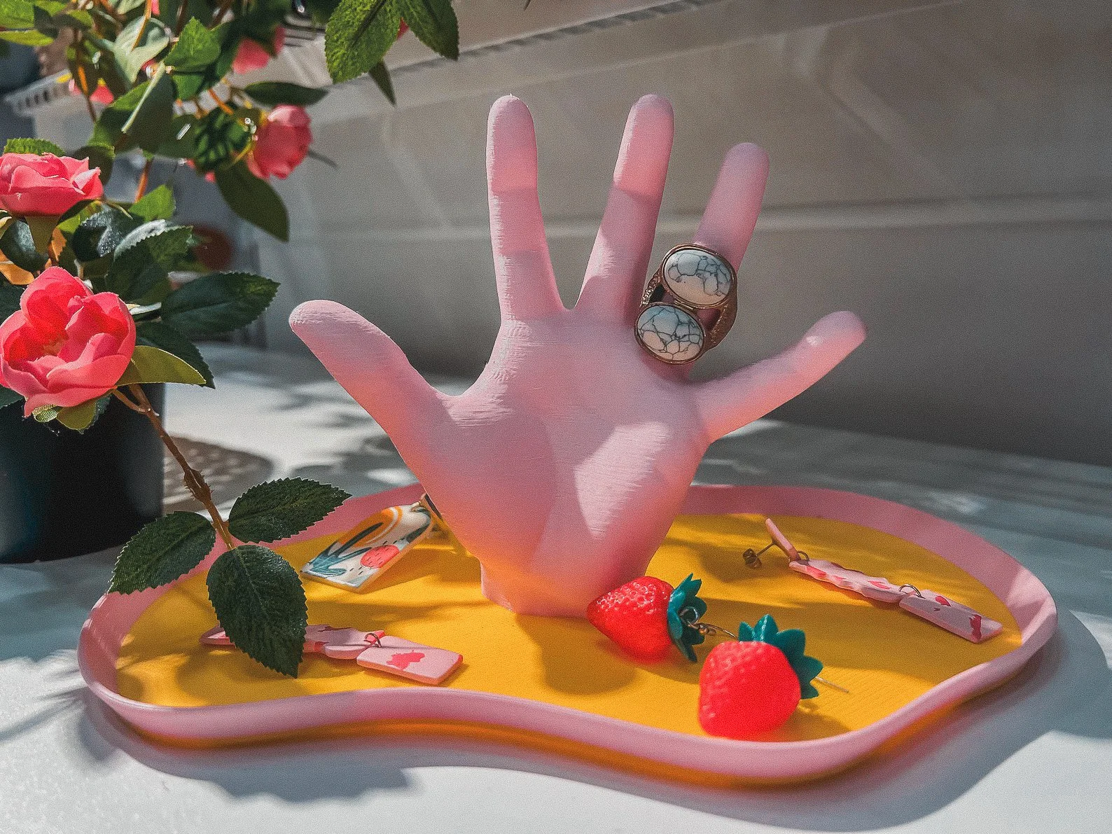 Stylish hand-shaped tray in glossy acrylic, perfect as a catchall for rings, keys, or trinkets with a modern art flair.