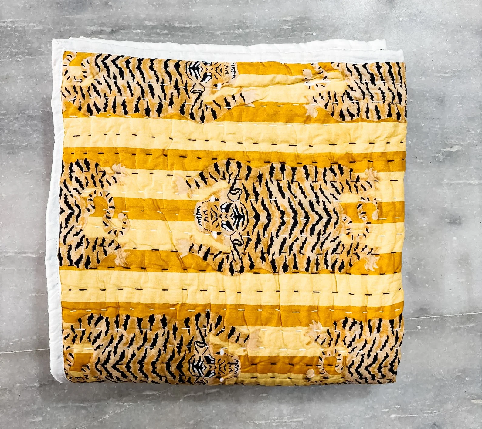 Adorable hand-stitched kantha baby quilt featuring tiger motifs, perfect for nurseries, jungle-themed decor, or unique baby shower gifts