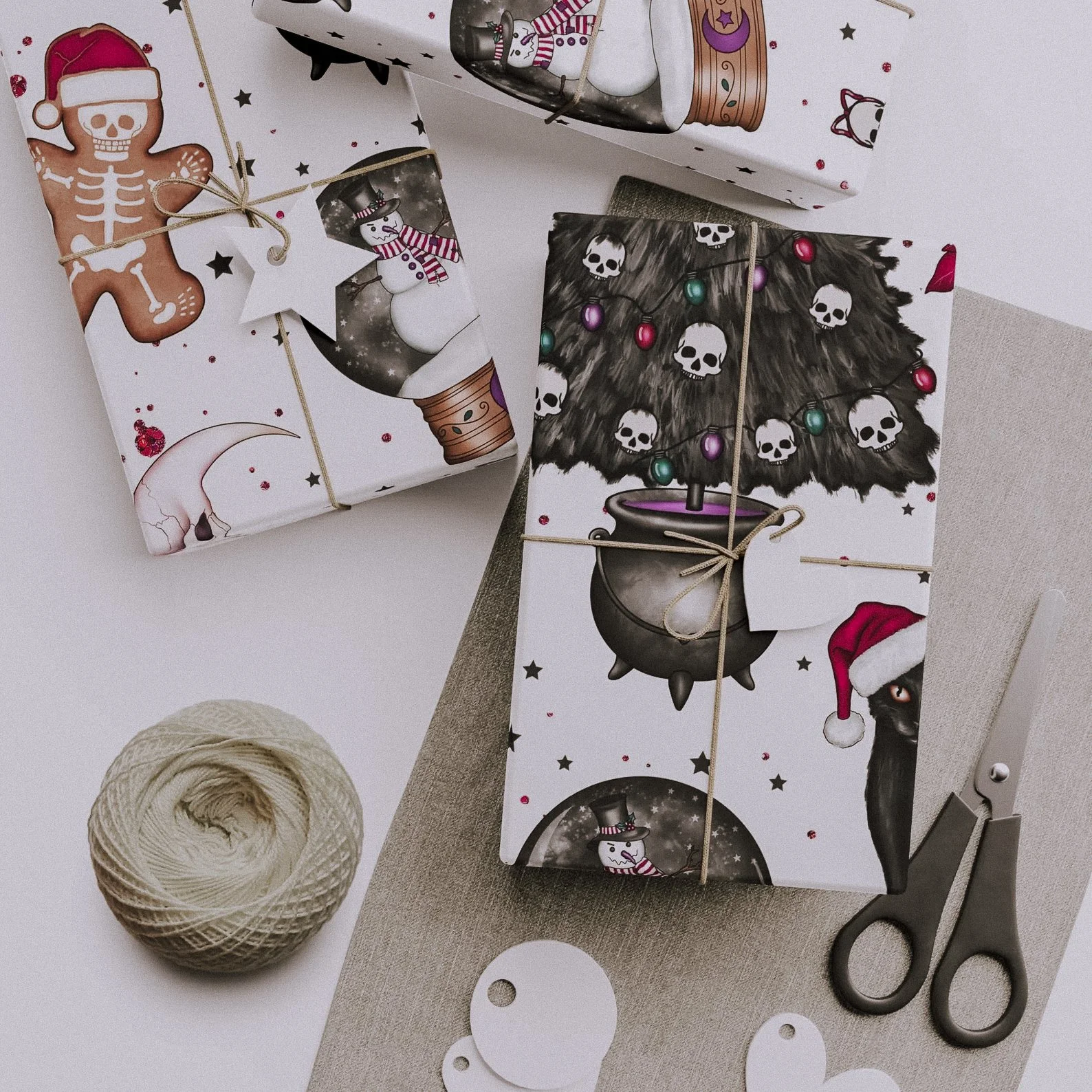 Spooky gift wrap covered in black cats, crescent moons, and witchy vibes, perfect for gothmas gifts and Halloween birthdays.