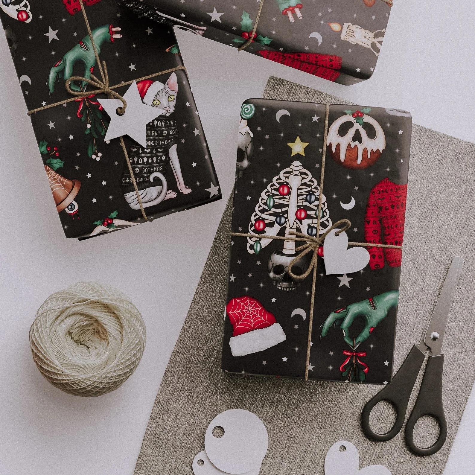Matte black and red gothic Christmas wrapping paper with vintage skeletons and spooky winter motifs, perfect for creepmas gift giving.