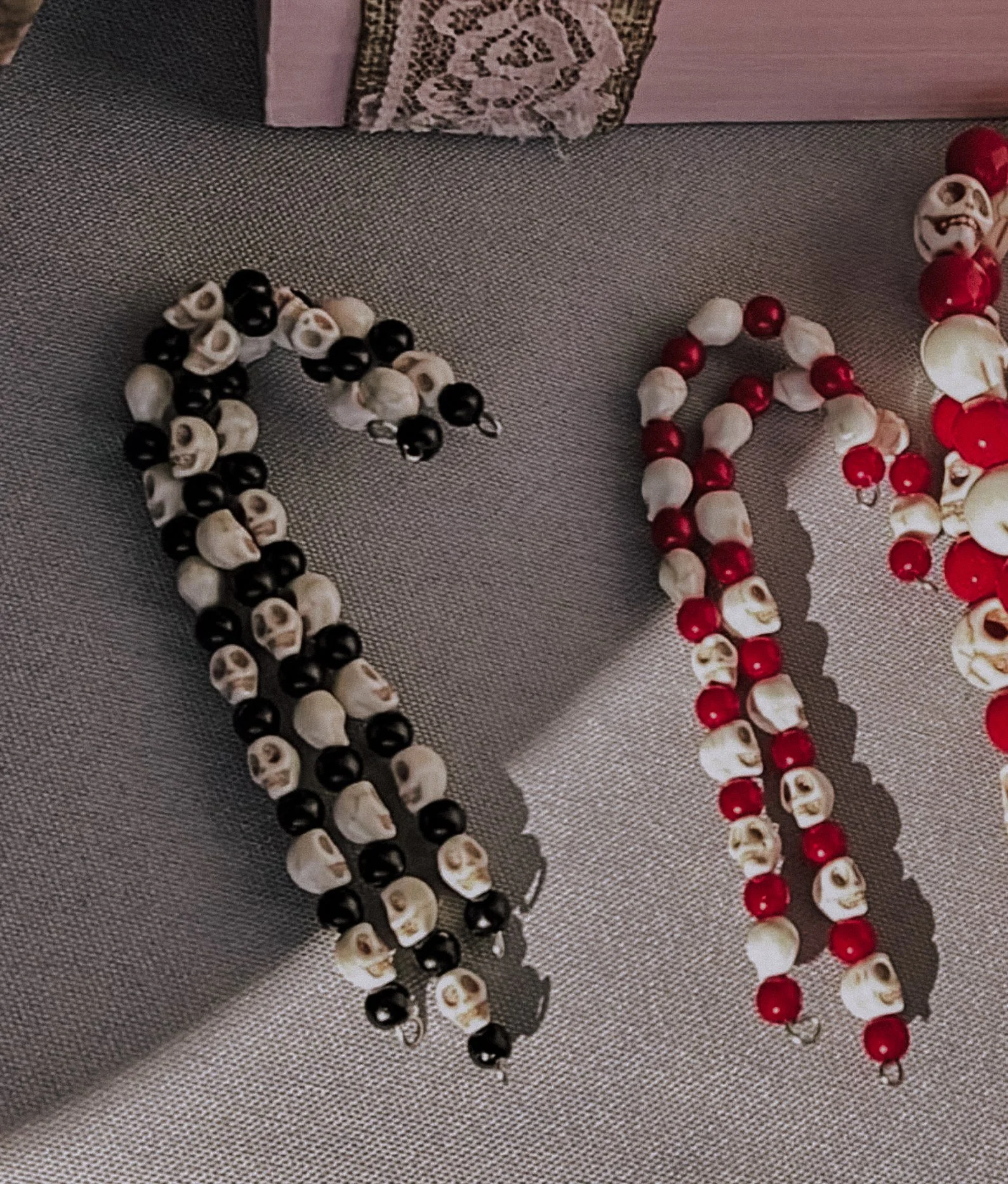 Black and white skull-shaped candy cane ornament for creepmas trees and horror-themed holiday setups.