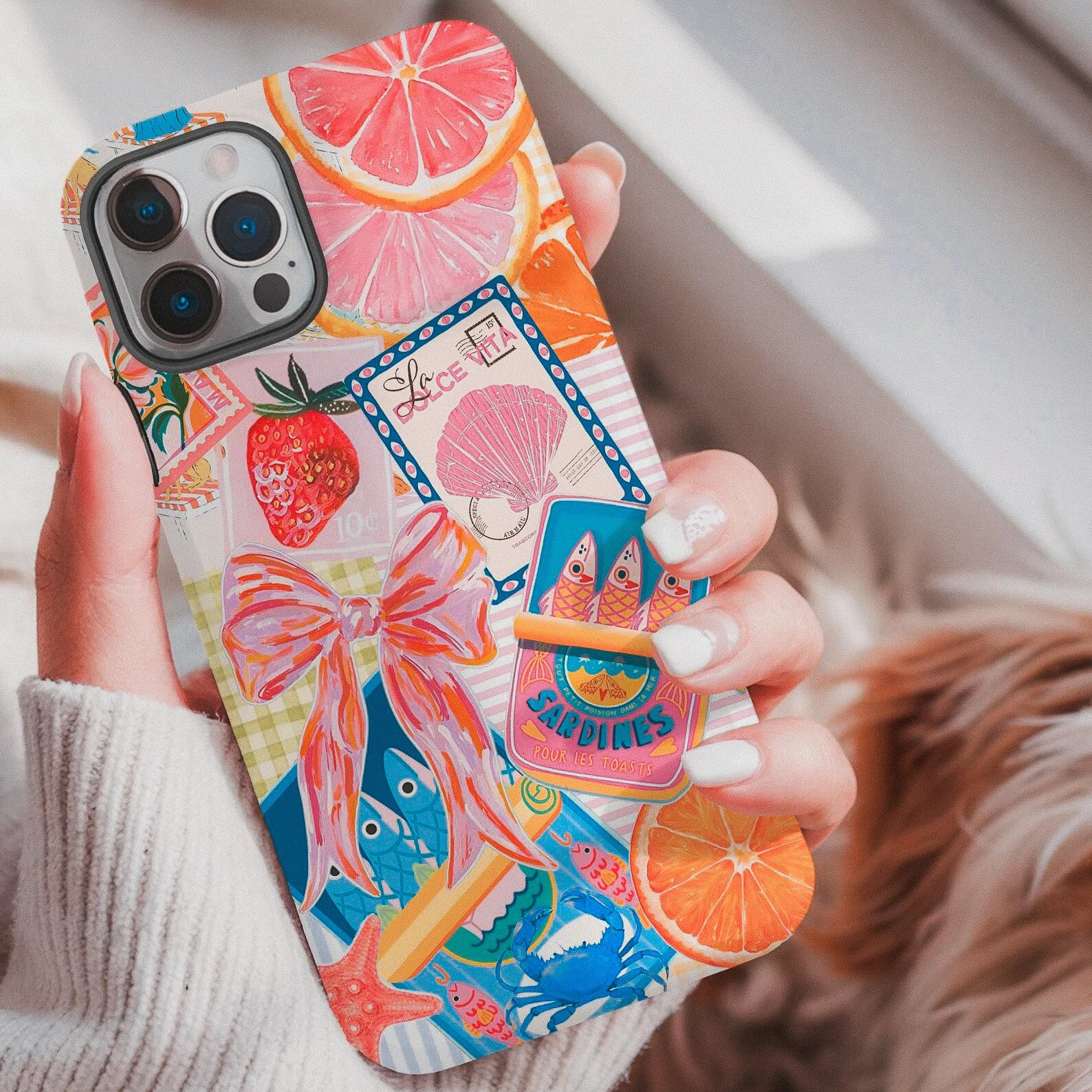 Colorful collage-style phone case featuring tropical fruits, flowers, and coquette details, perfect for aesthetic maximalist phone flair.