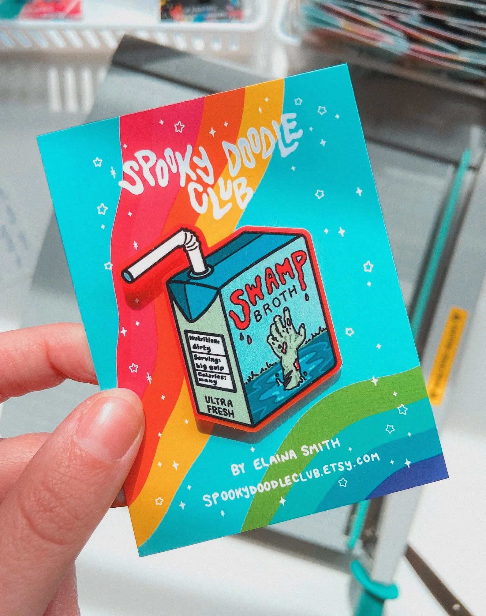 This swamp monster juicebox pin is serving cryptid core realness with a side of radioactive refreshment. Featuring a gooey little beast and his questionable drink of choice, Swamp Broth, this enamel pin is perfect for fans of weird cryptids, gross-ou
