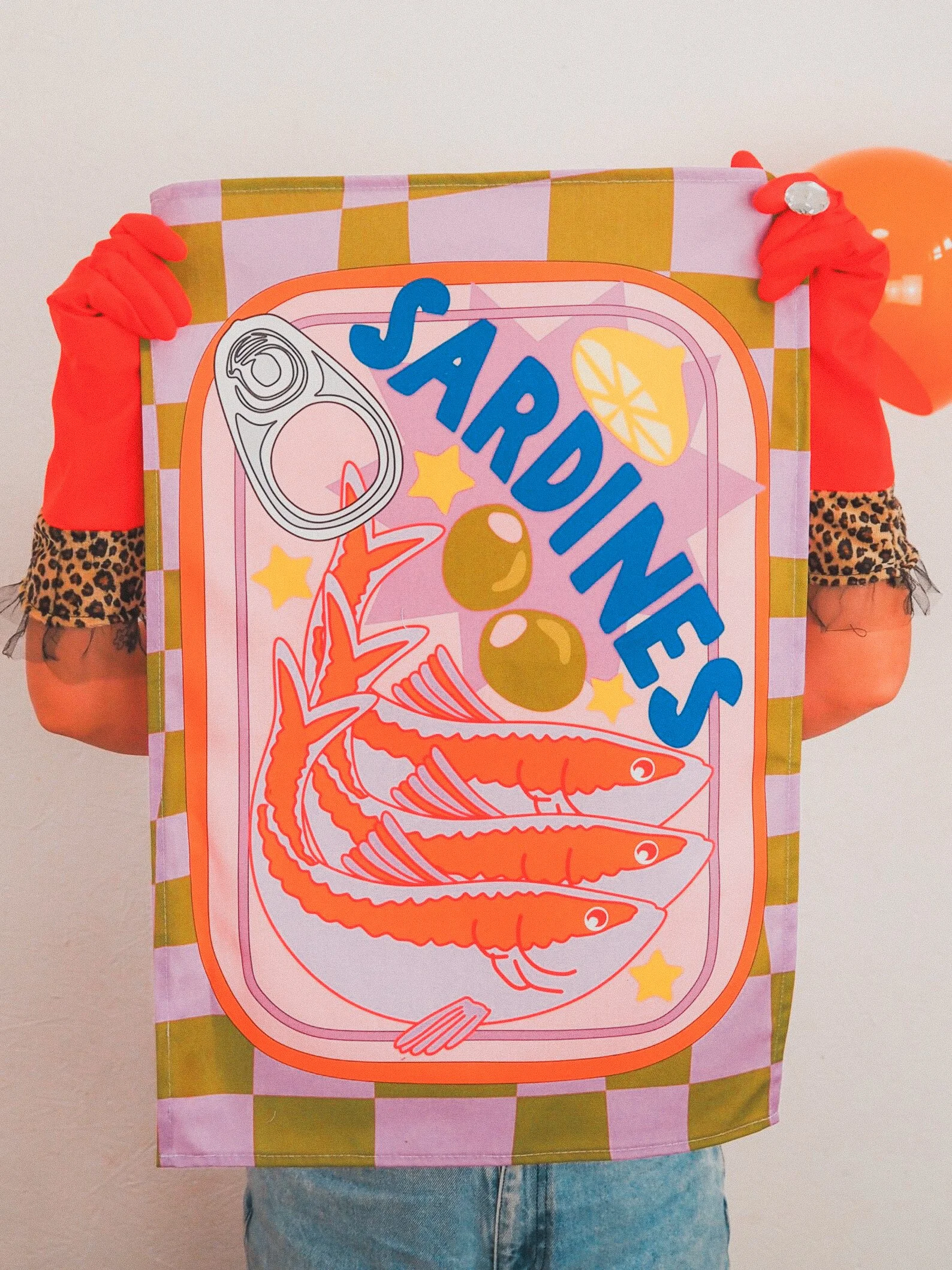 Quirky tea towel featuring a colorful retro sardine tin design, perfect for foodie kitchens, seafood lovers, or vintage-themed spaces.