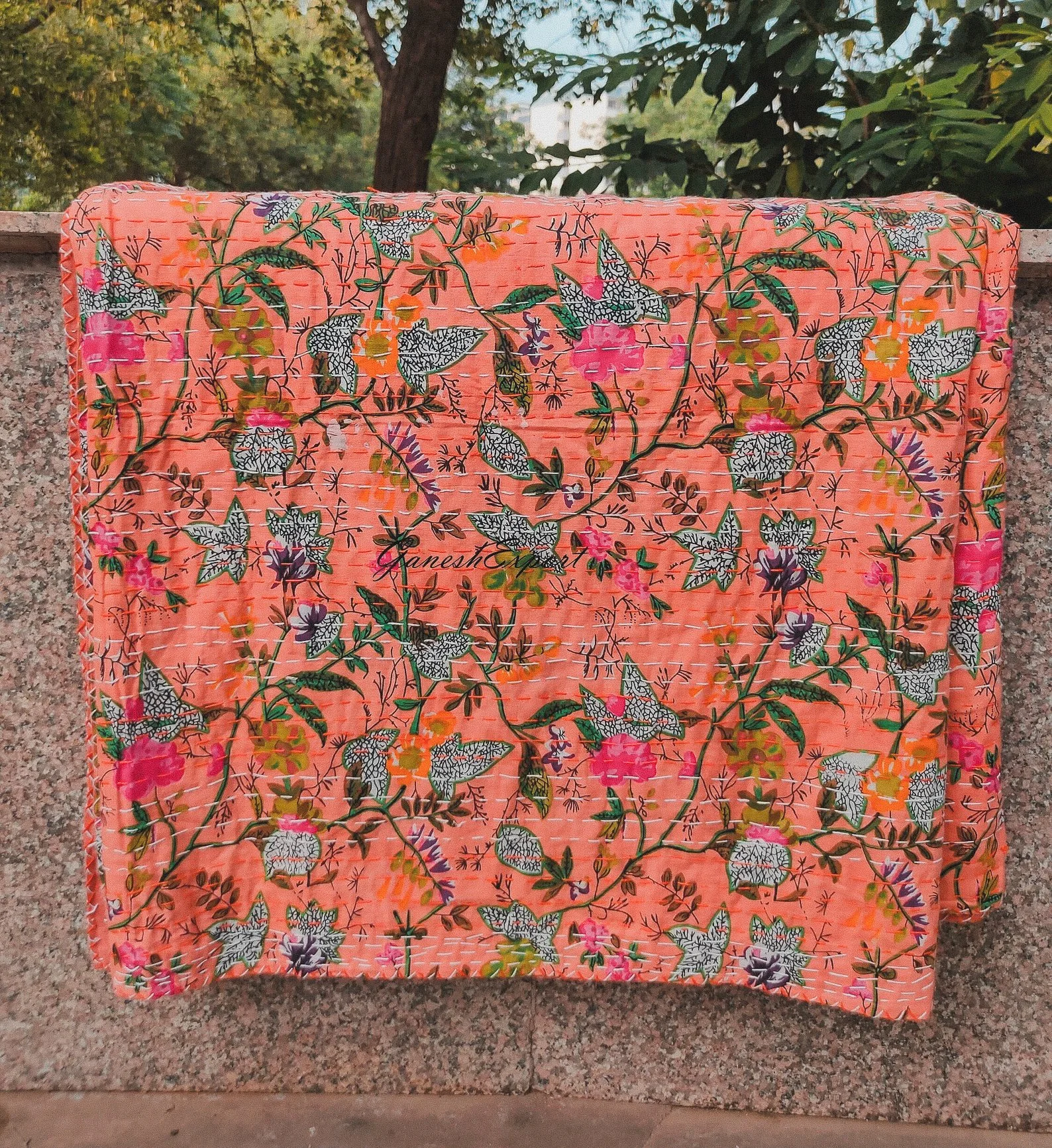 One-of-a-kind Indian kantha quilt featuring vibrant floral patterns and hand-stitched details, perfect as a cozy throw or boho bedspread.