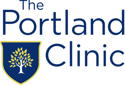 Logo of The Portland Clinic with a blue shield featuring a yellow tree, and the clinic's name in blue text.