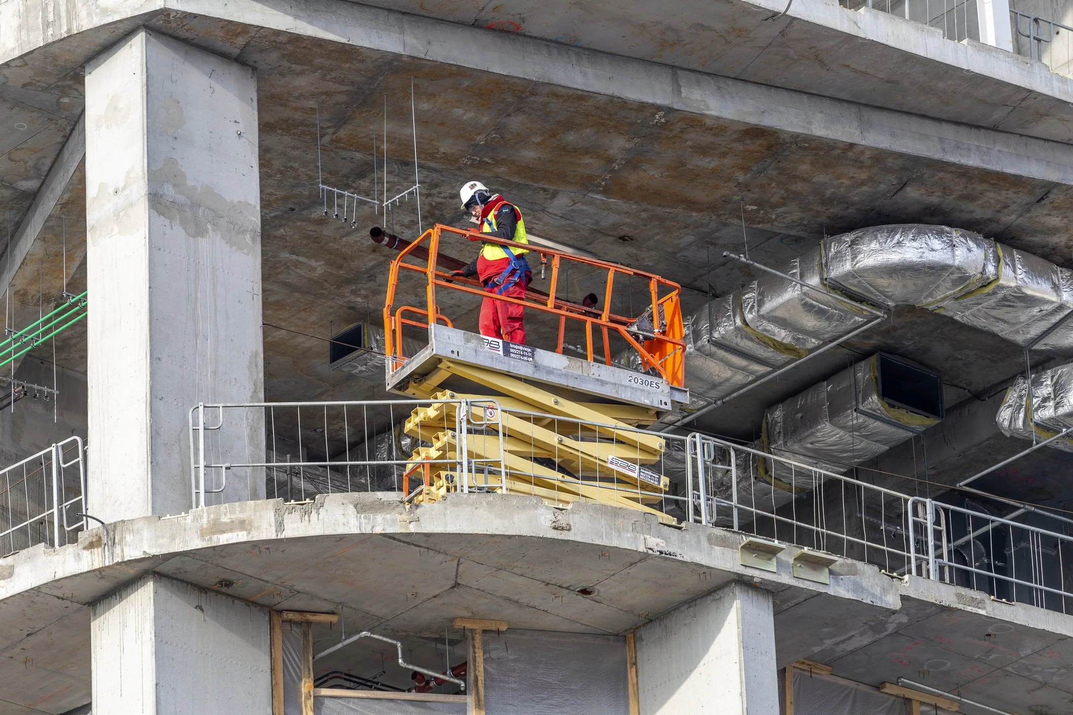 Worker inspecting a commercial construction site in Western Australia.