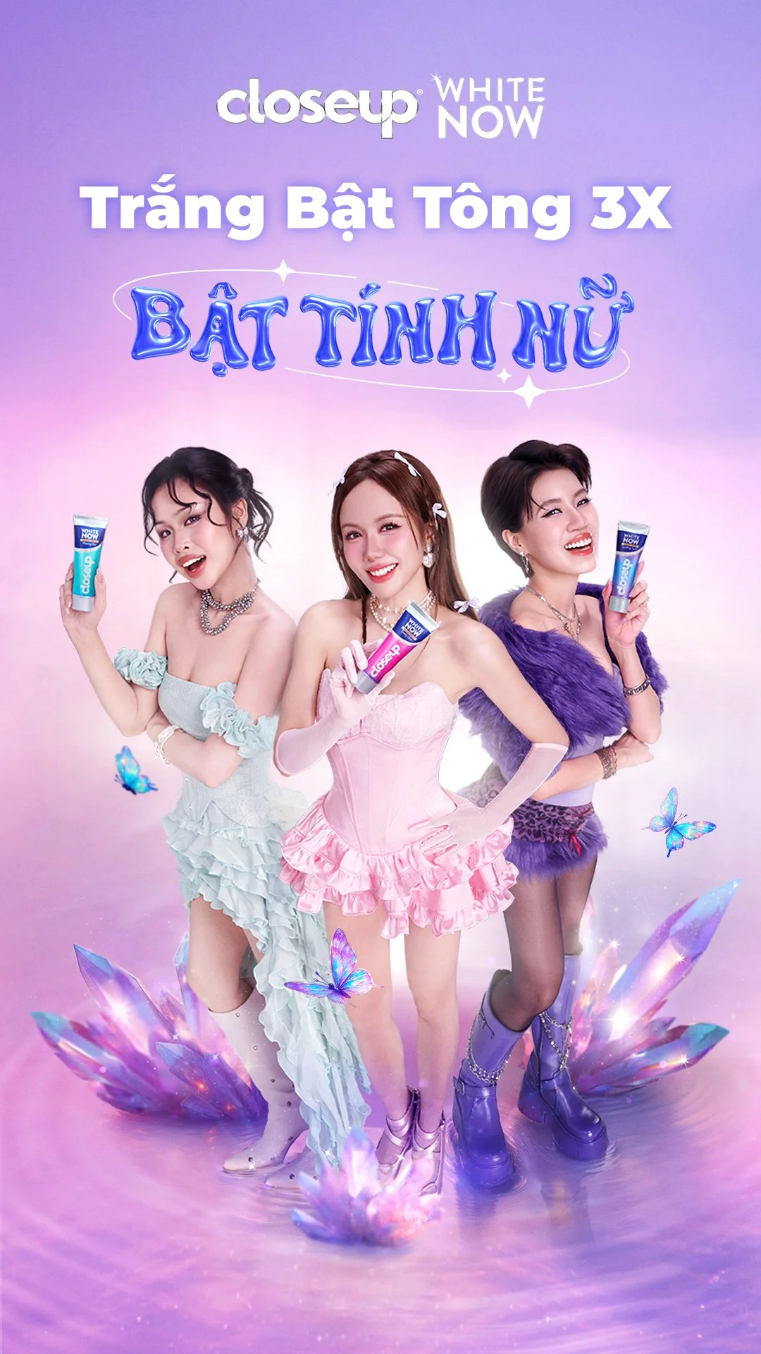 Three women holding closeup tubes of Closeup toothpaste with a purple and pink fantasy background featuring butterflies and crystals.