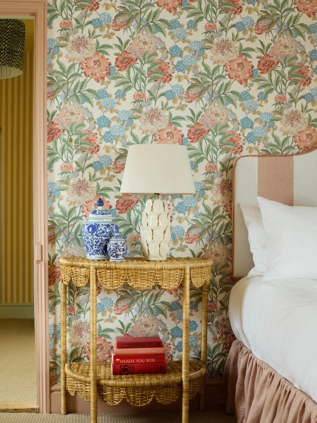 Guest bedrooms should feel like a treat!

This newly reconfigured space pairs bespoke joinery with playful pattern to create something both luxurious and inviting. Cane-front wardrobes, soft peach tones and layered florals bring warmth and character,