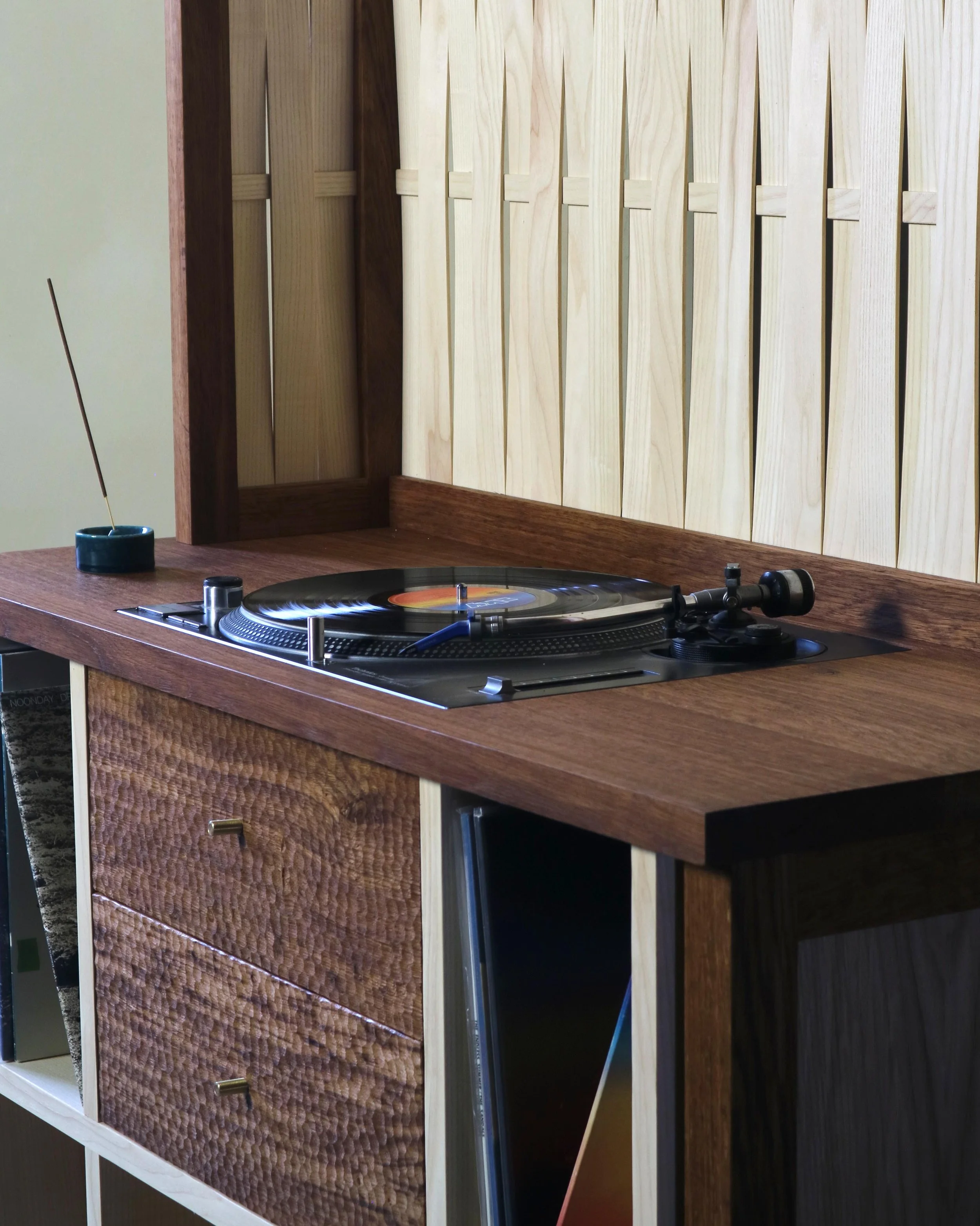 Detail of chip-carved drawer fronts and woven ash laths on a handcrafted British oak and ash record cabinet