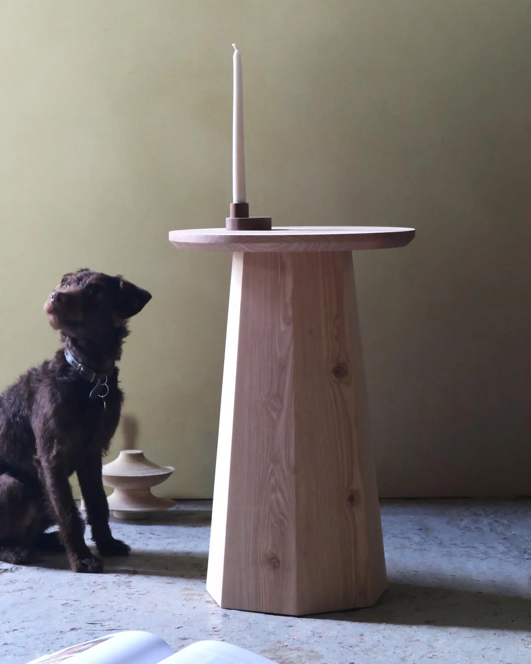 Handcrafted Coopered Side Table inspired by traditional barrel making, showcasing solid timber with a sculptural yet elegant form with workshop dog in shot