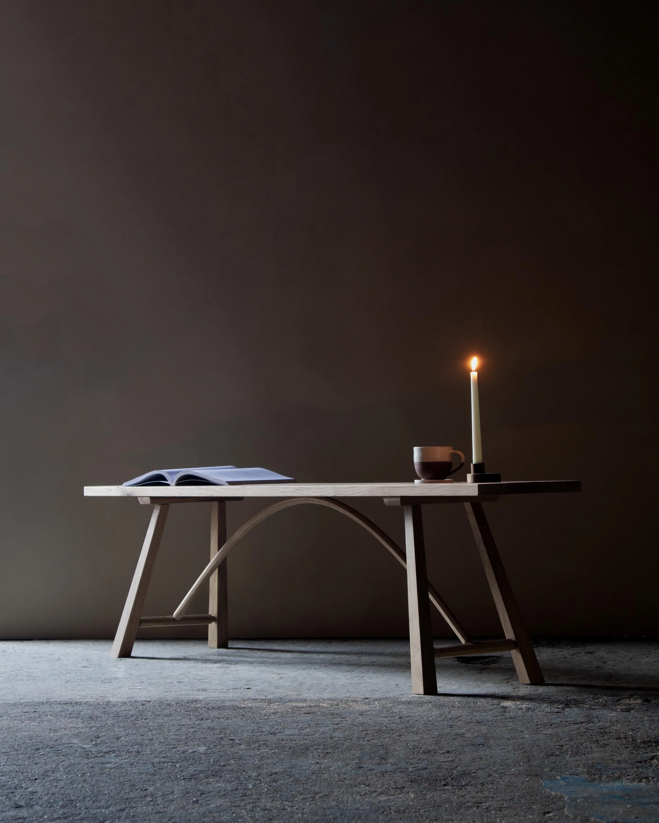 Handcrafted Le Coubre bench made from locally sourced British oak with traditional farmhouse design and curved rail detail