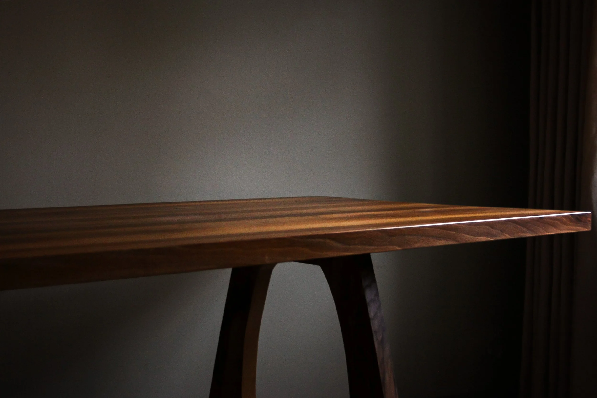 Handmade English walnut dining table with bold sculptural legs