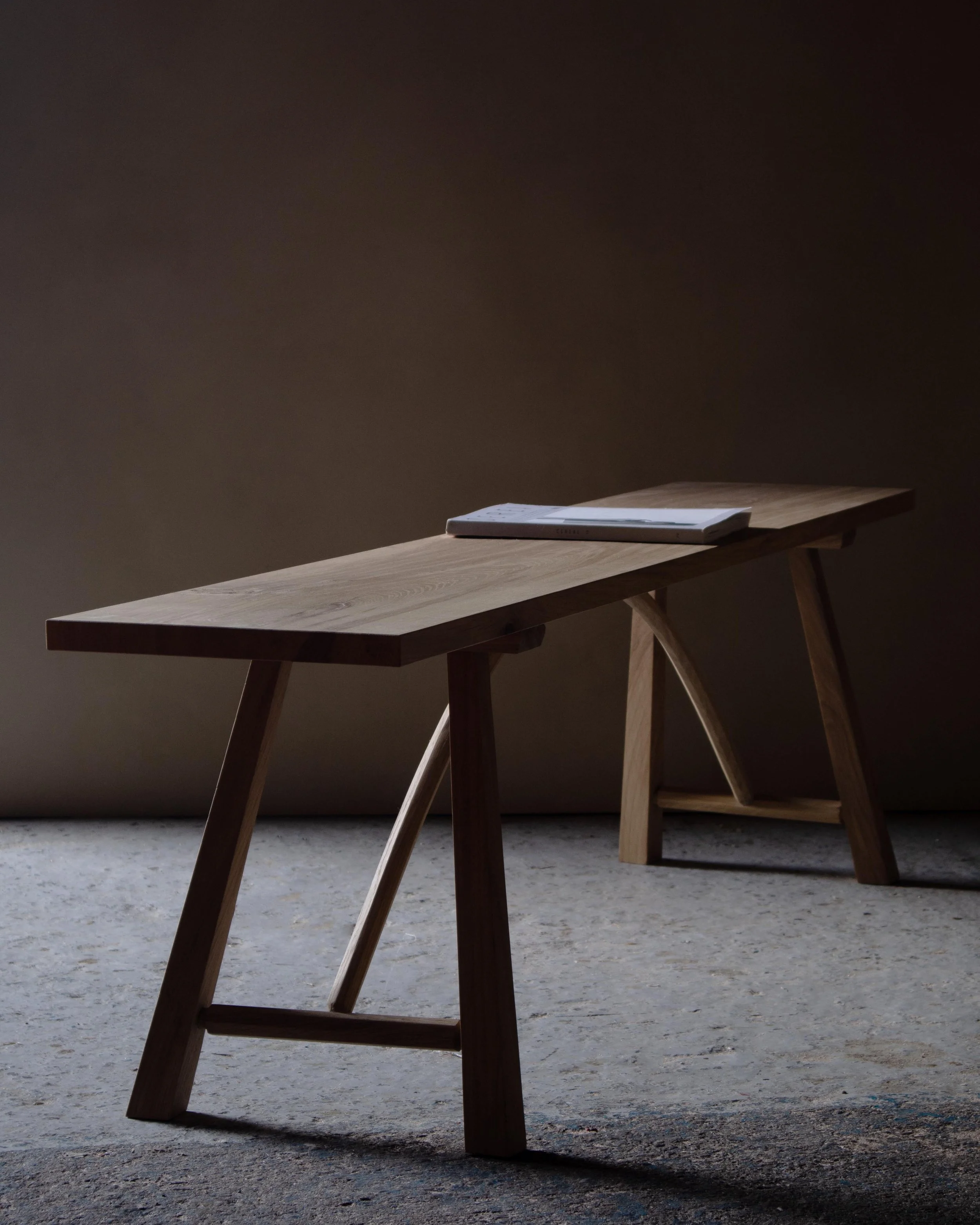 Handcrafted Le Coubre bench made from locally sourced British oak with traditional farmhouse design and curved rail detail