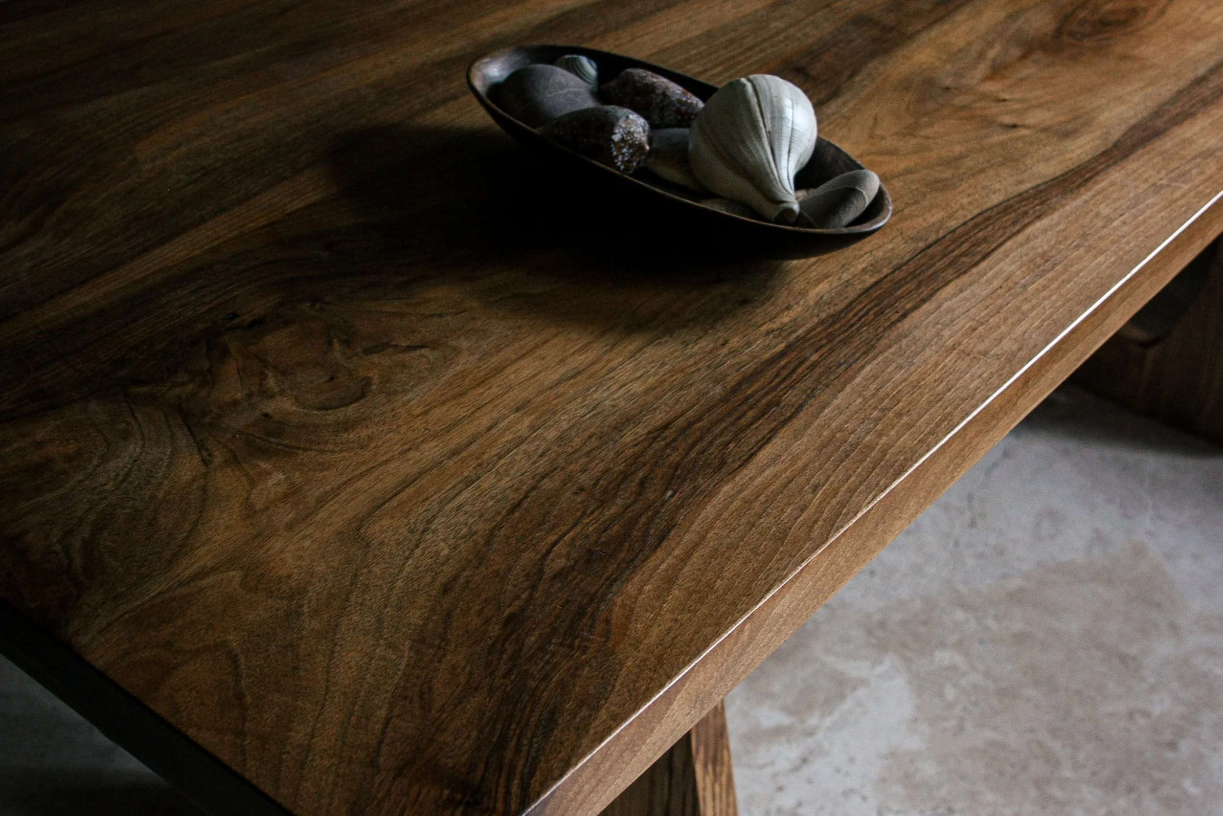 Handmade English walnut dining table with bold sculptural legs