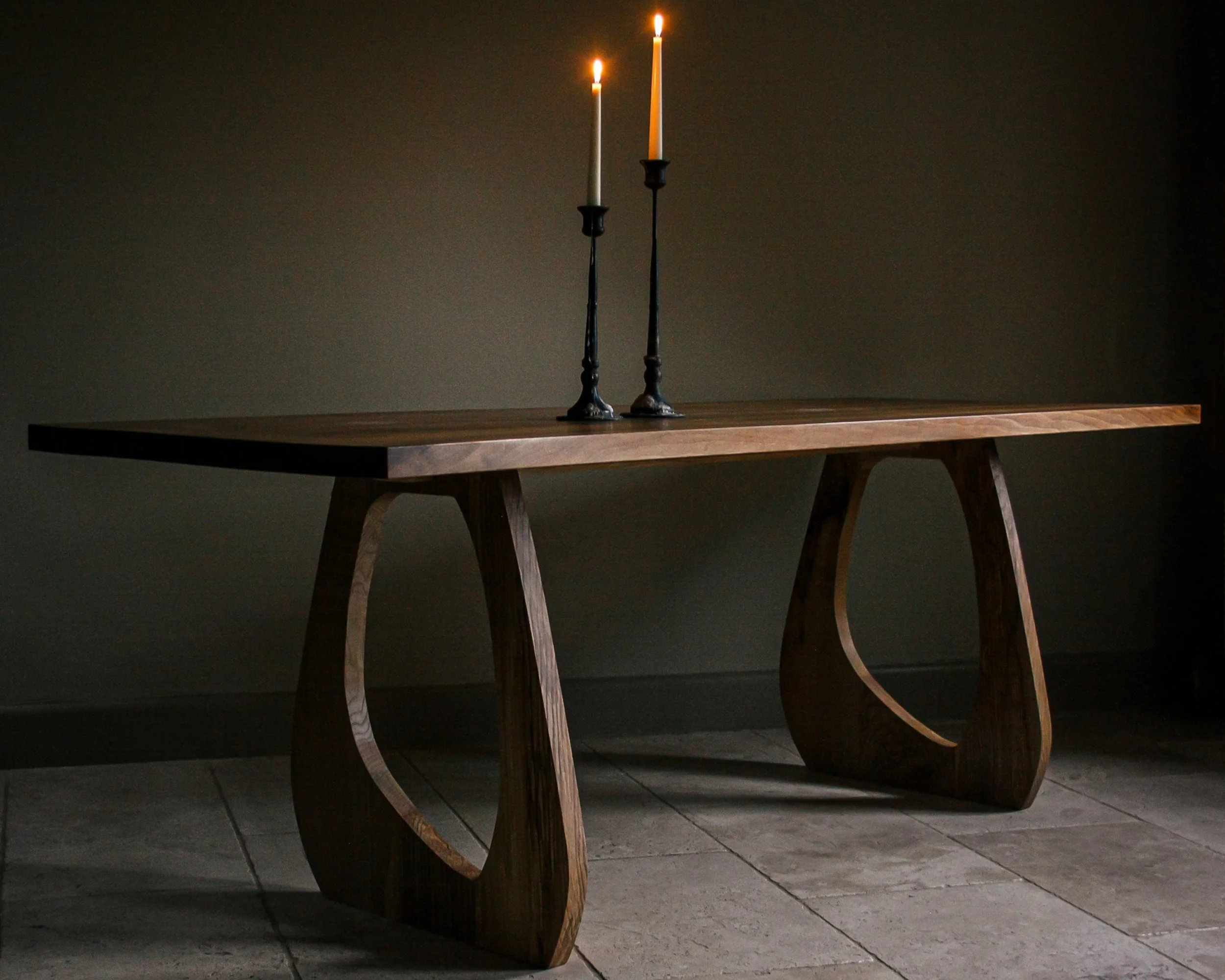 Handmade English walnut dining table with bold sculptural legs