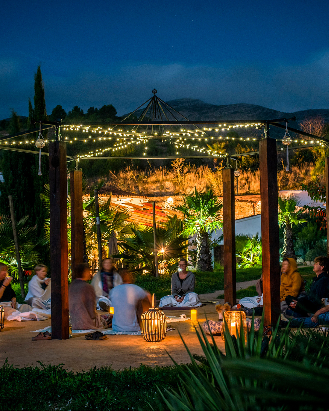 Wellness travelers enjoying guided meditation at sunset at a SunKiss Yoga Retreat in Mallorca.