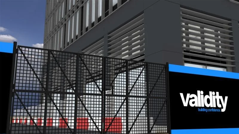 Modern building with a black security gate and a signage that reads 'Validity building confidence'.
